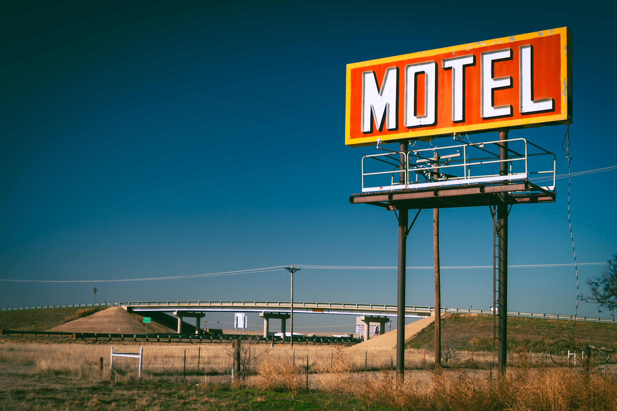 A billboard advertising at hotel in Adrian, Texas, stands watch over nearby Interstate 40.