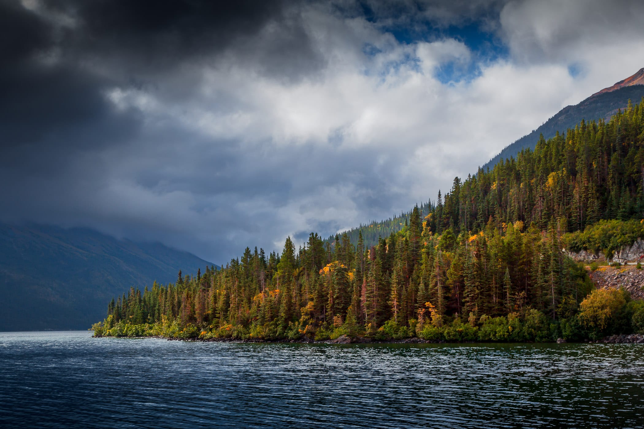 Low storm clouds roll in over the mountains surrounding British Columbia, Canada’s Tutshi Lake.