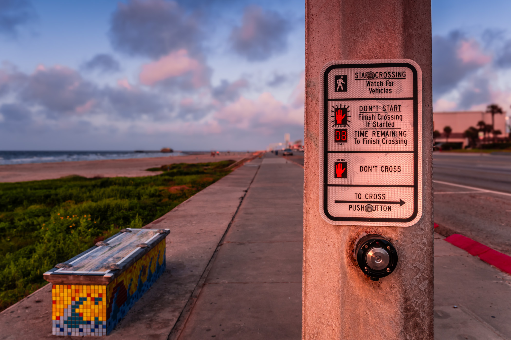 The early-morning sun illuminates a crosswalk on the seawall at Galveston, Texas.