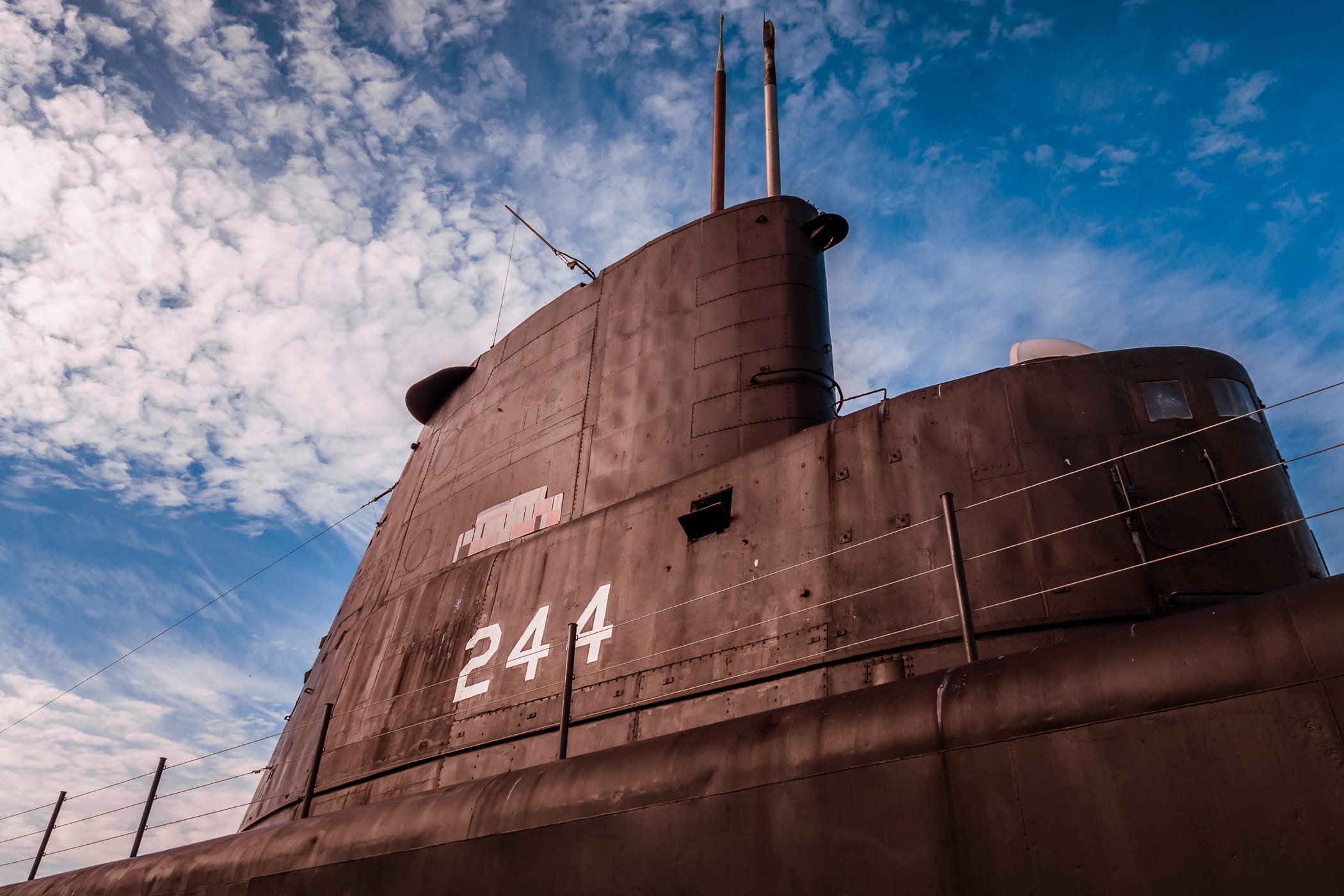 The sail (or conning tower) of the Gato-class submarine USS Cavalla rises into the late afternoon sky over Galveston, Texas' Seawolf Park.