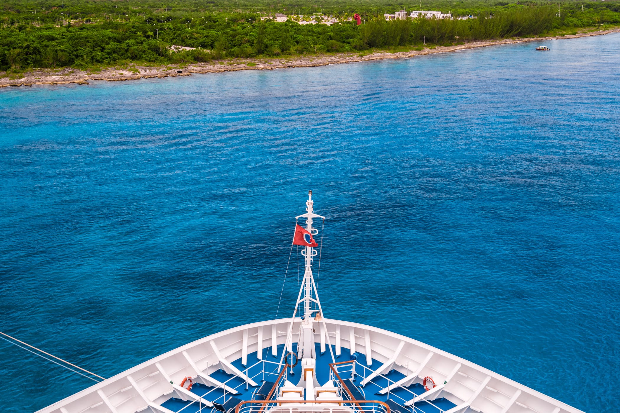 The bow of the cruise ship Carnival Breeze floats in the blue waters just off the coast of Cozumel, Mexico.