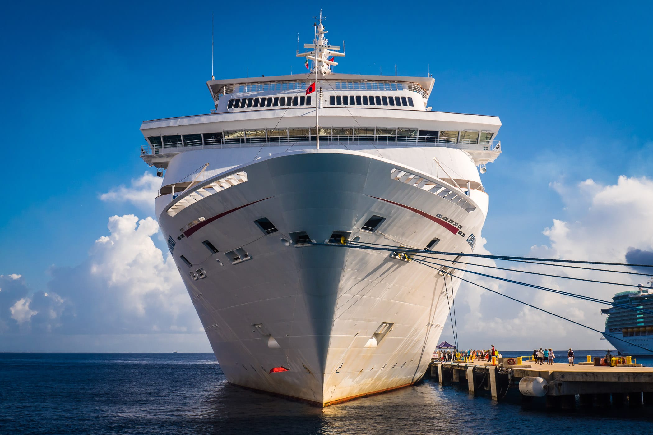 The bow of the cruise ship Carnival Fantasy looms over the adjacent pier at Cozumel, Mexico.