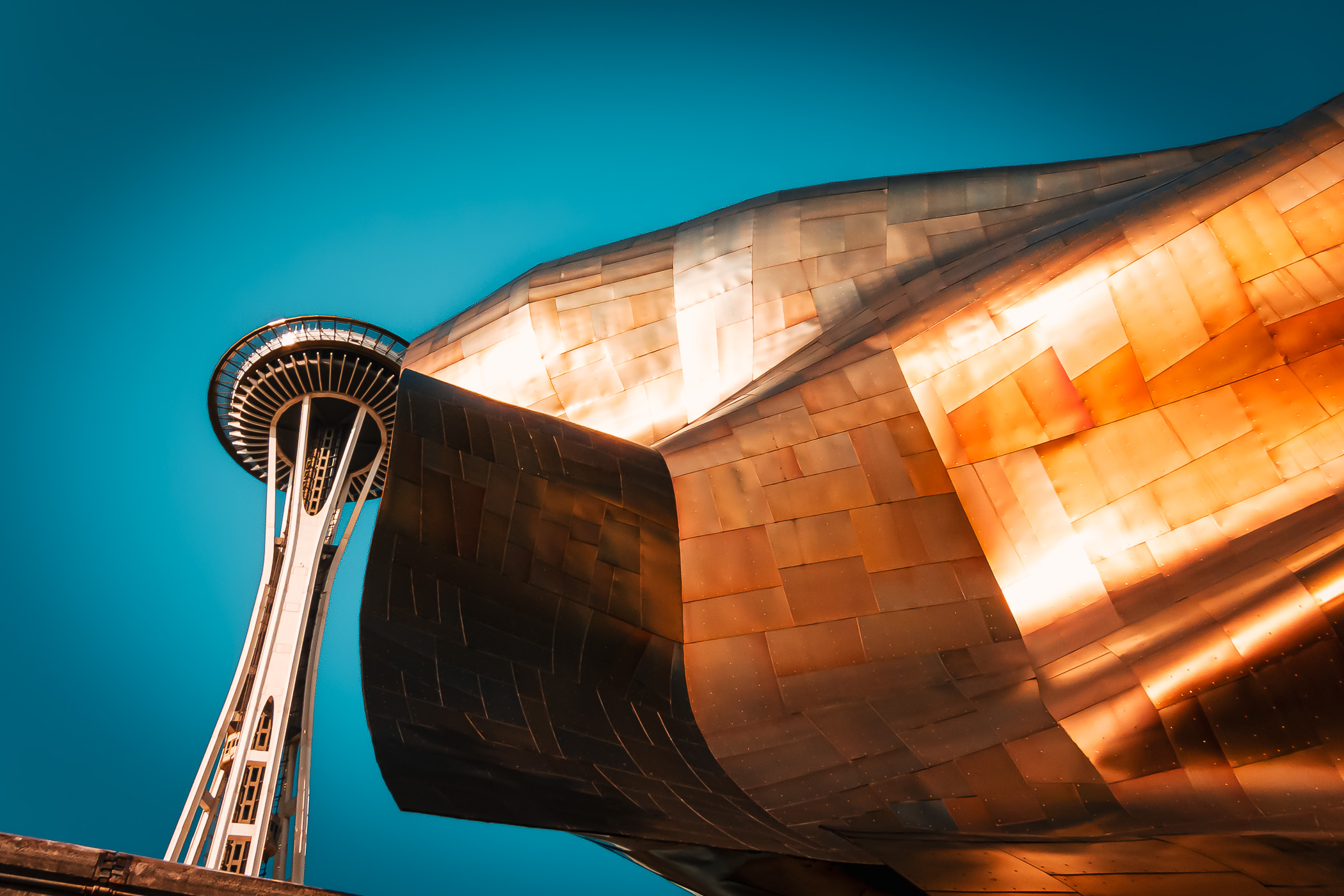 The Frank Gehry-designed Museum of Pop Culture (formerly the EMP Museum) obscures a portion of the adjacent Space Needle at the Seattle Center.