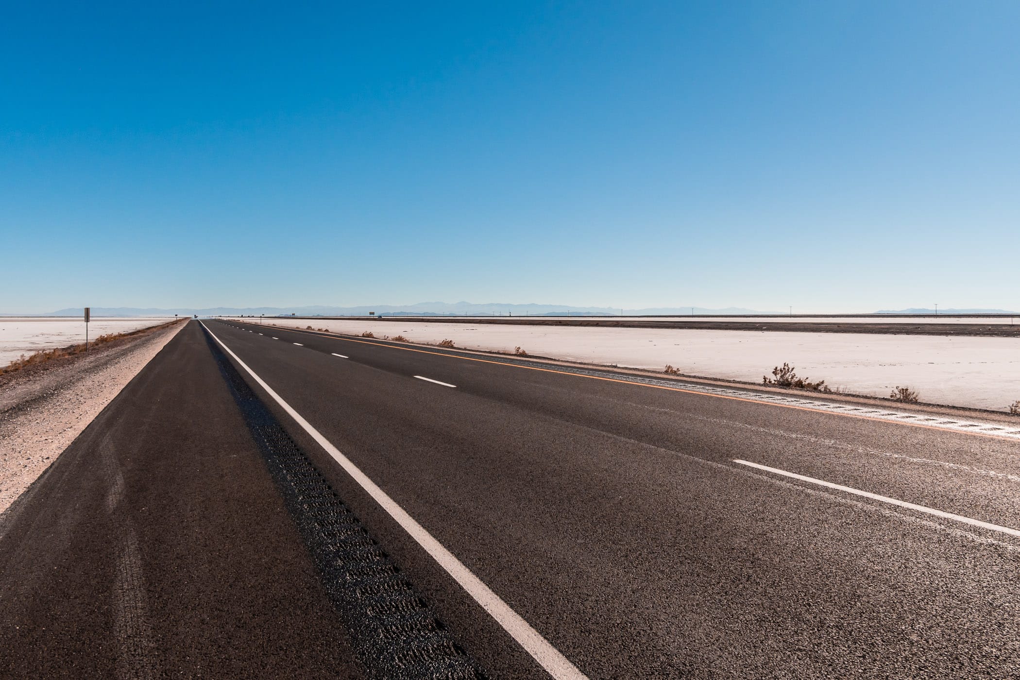 Interstate 80 traverses the arid expanse of the Bonneville Salt Flats, Utah.