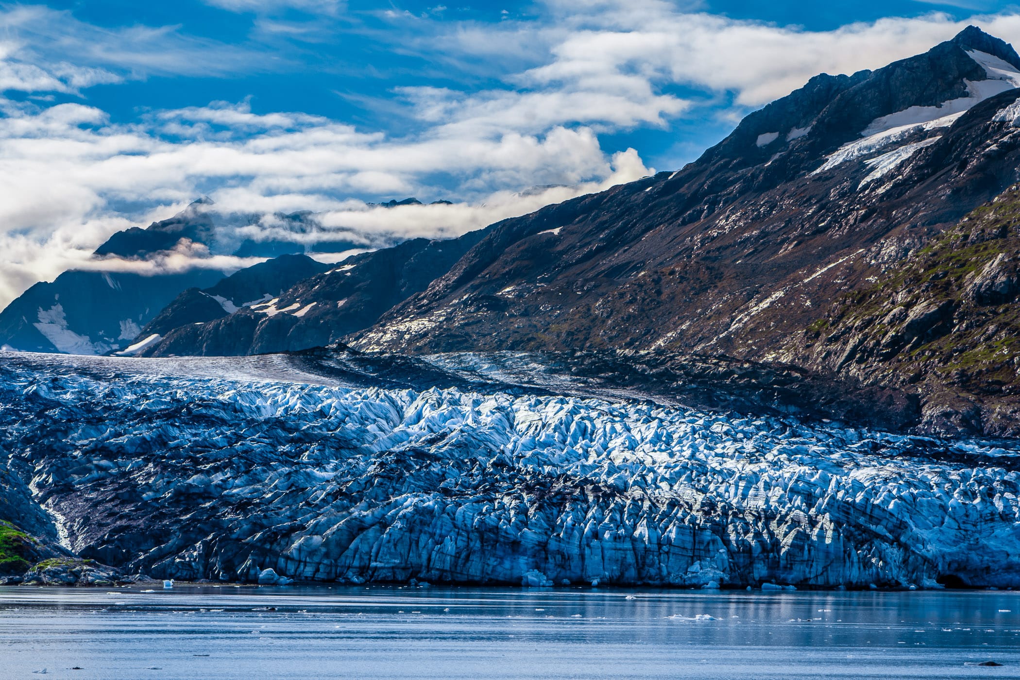 The blue ice of Lamplugh Glacier hugs the coastline of Alaska's Glacier Bay.
