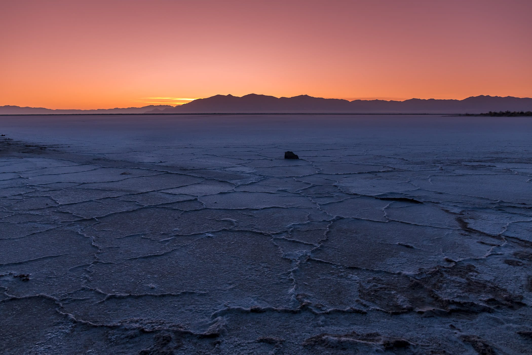 The sun rises on the dried salt flat shore of the Great Salt Lake, Utah.