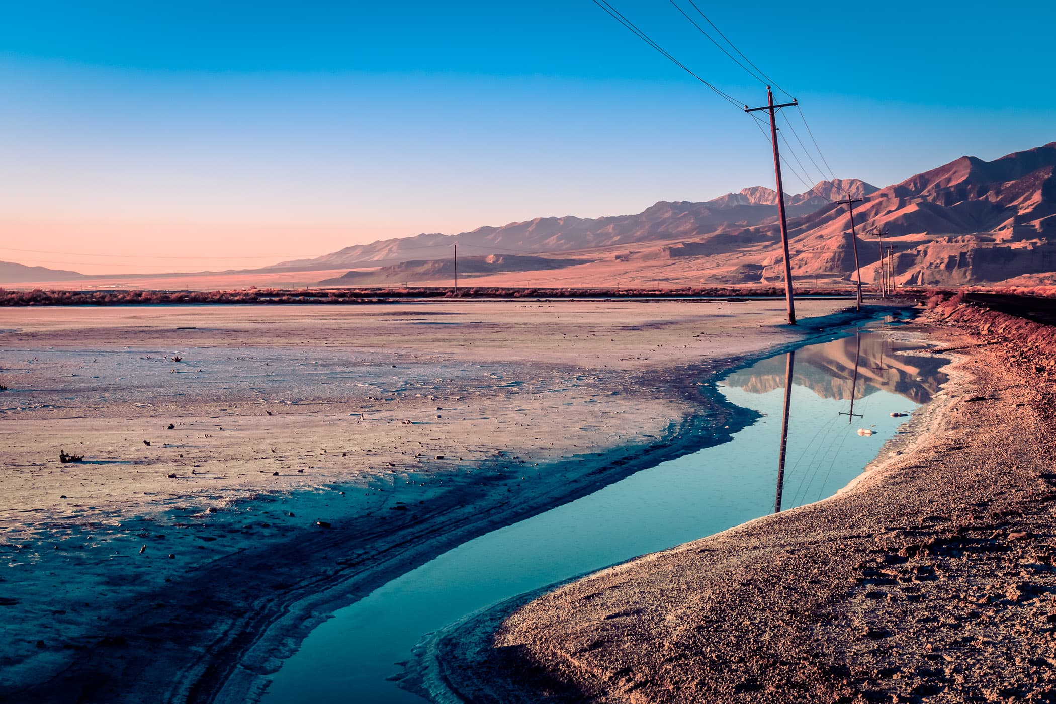 Power lines stretch along the road to Utah's Stansbury Island along the shore of the Great Salt Lake.