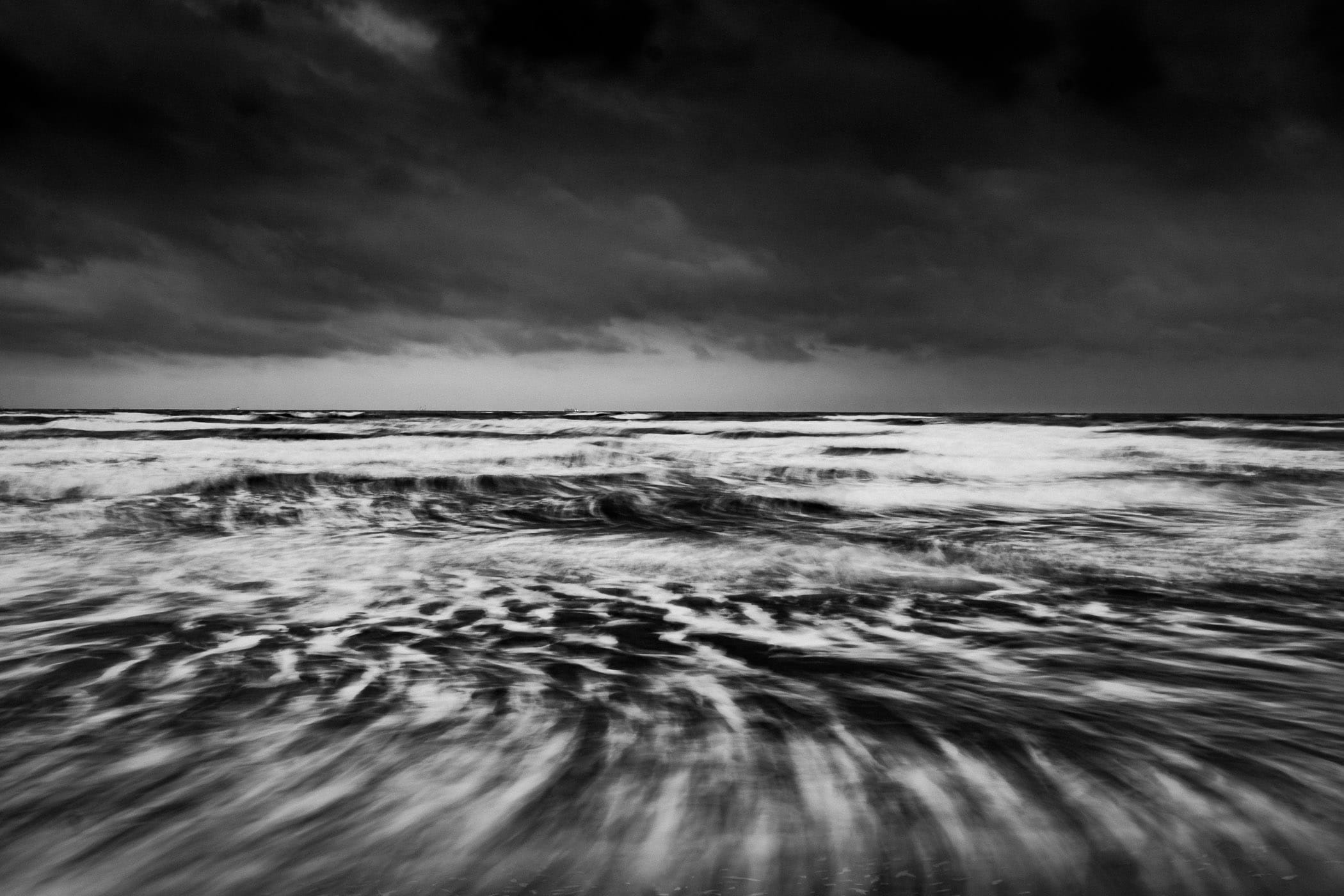 A long-exposure photo smooths the dynamic Gulf of Mexico along the Galveston, Texas, beach.
