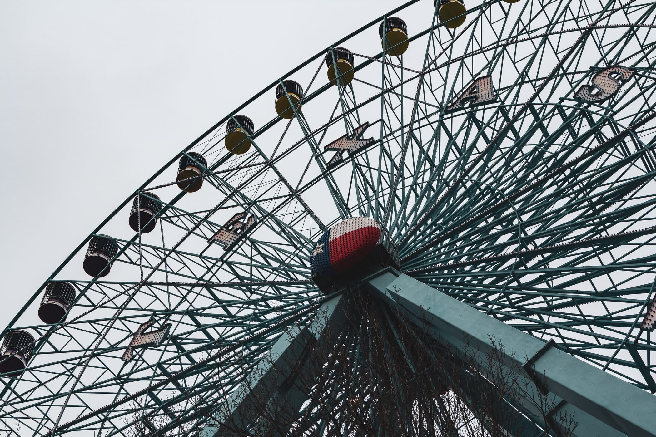 The Texas Star Ferris wheel rises into the overcast sky over Dallas' Fair Park.