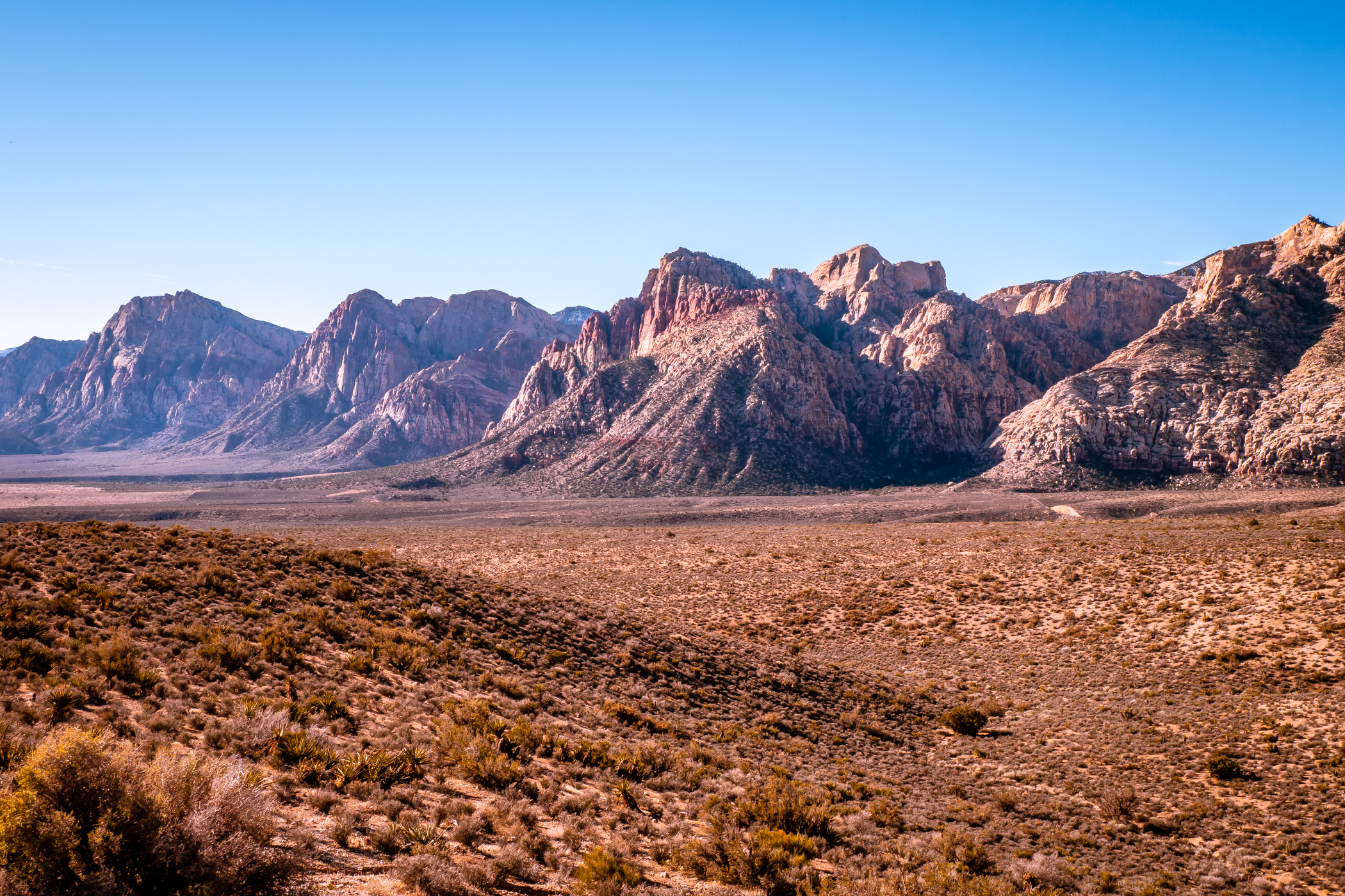 A mountain range stretches into the distance at Nevada's Red Rock Canyon.