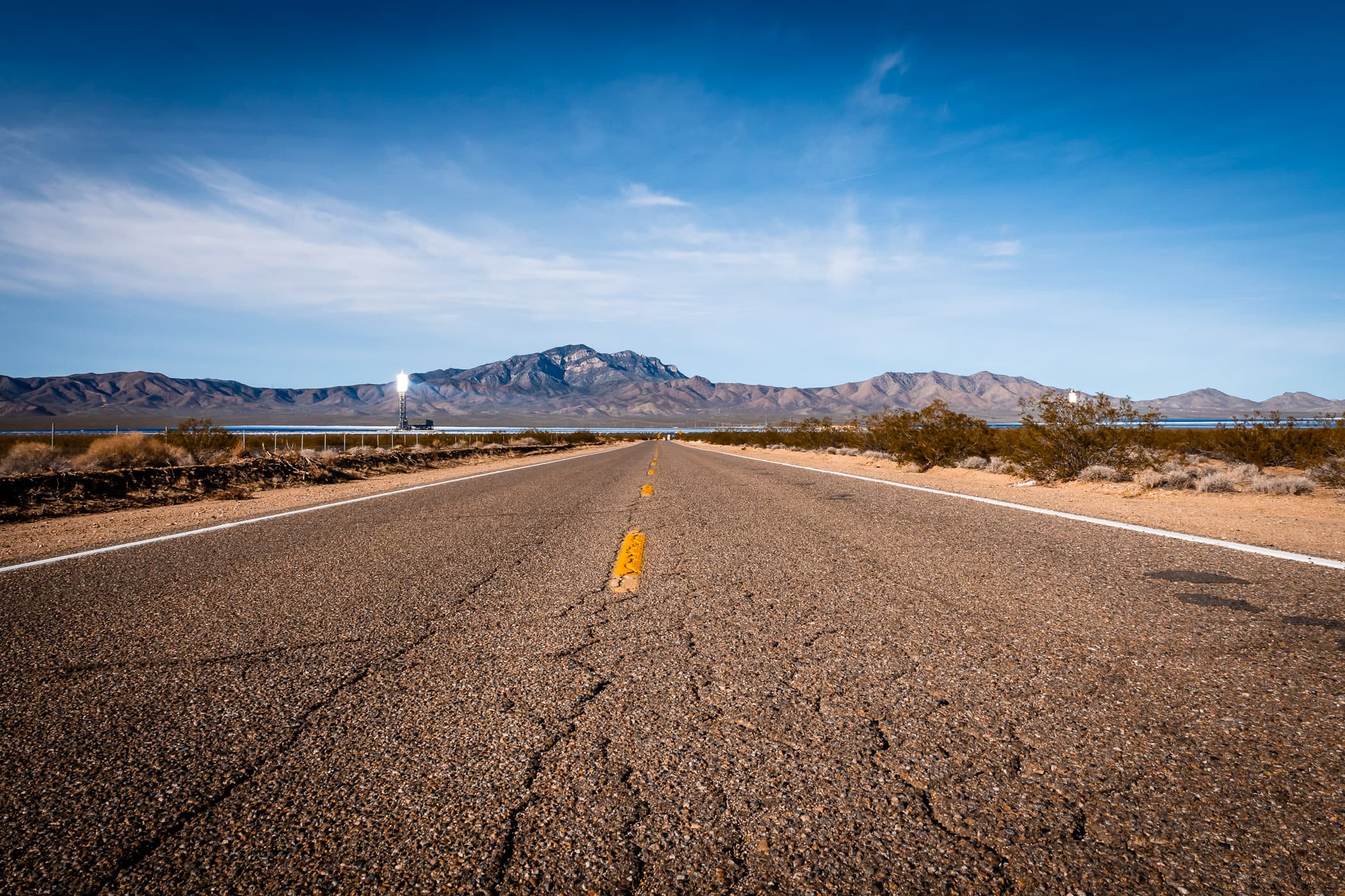 A lonely road leads to the Ivanpah Solar Power Facility in the California desert near the Nevada border.