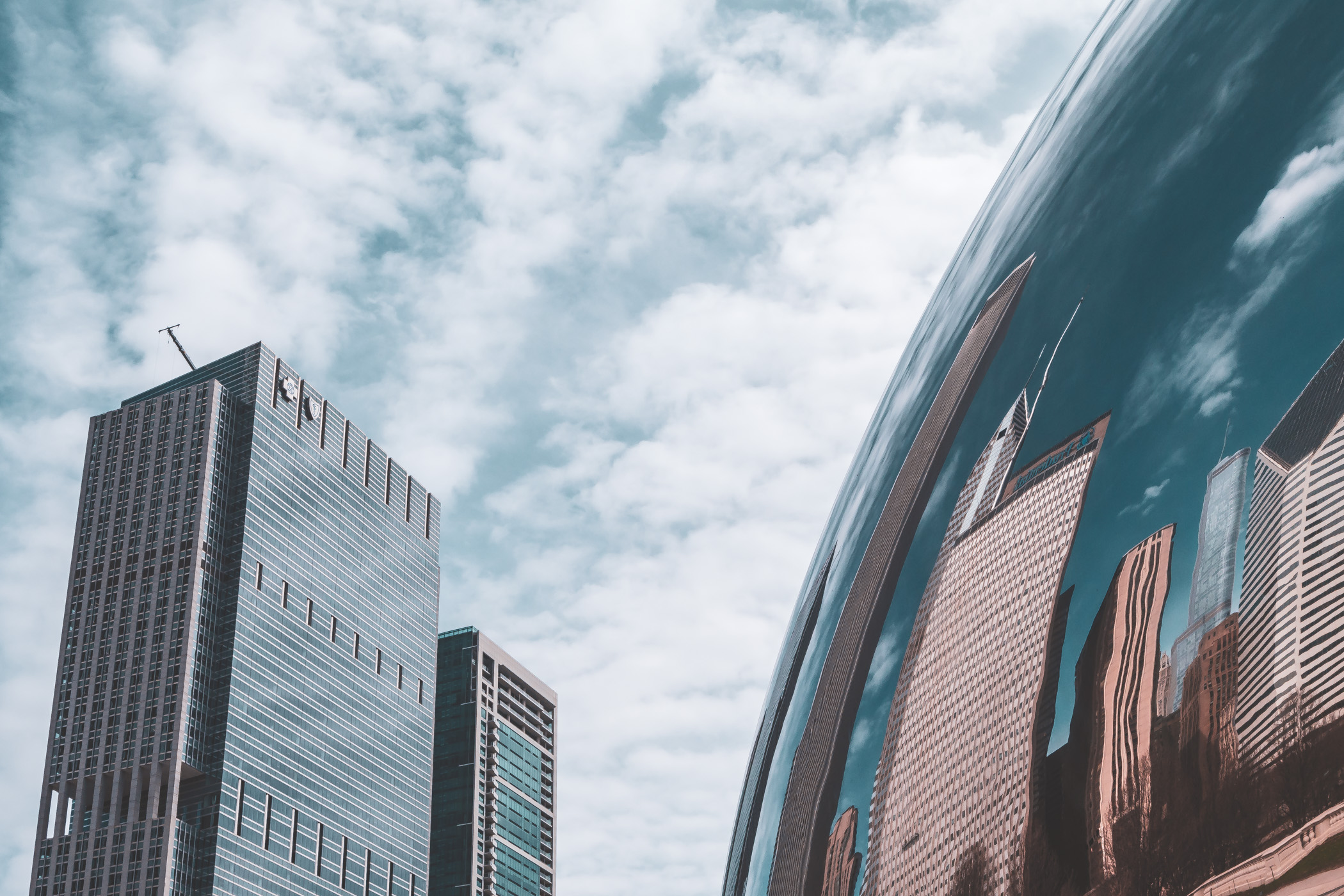 Chicago's Blue Cross-Blue Shield Tower and 340 on the Park rise above Anish Kapoor’s Cloud Gate, colloquially known as “The Bean”.