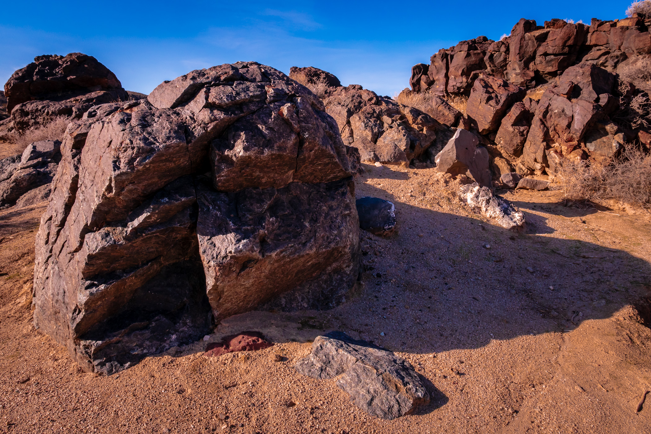 Ancient rocks cast late afternoon shadows in California's Mojave National Preserve.