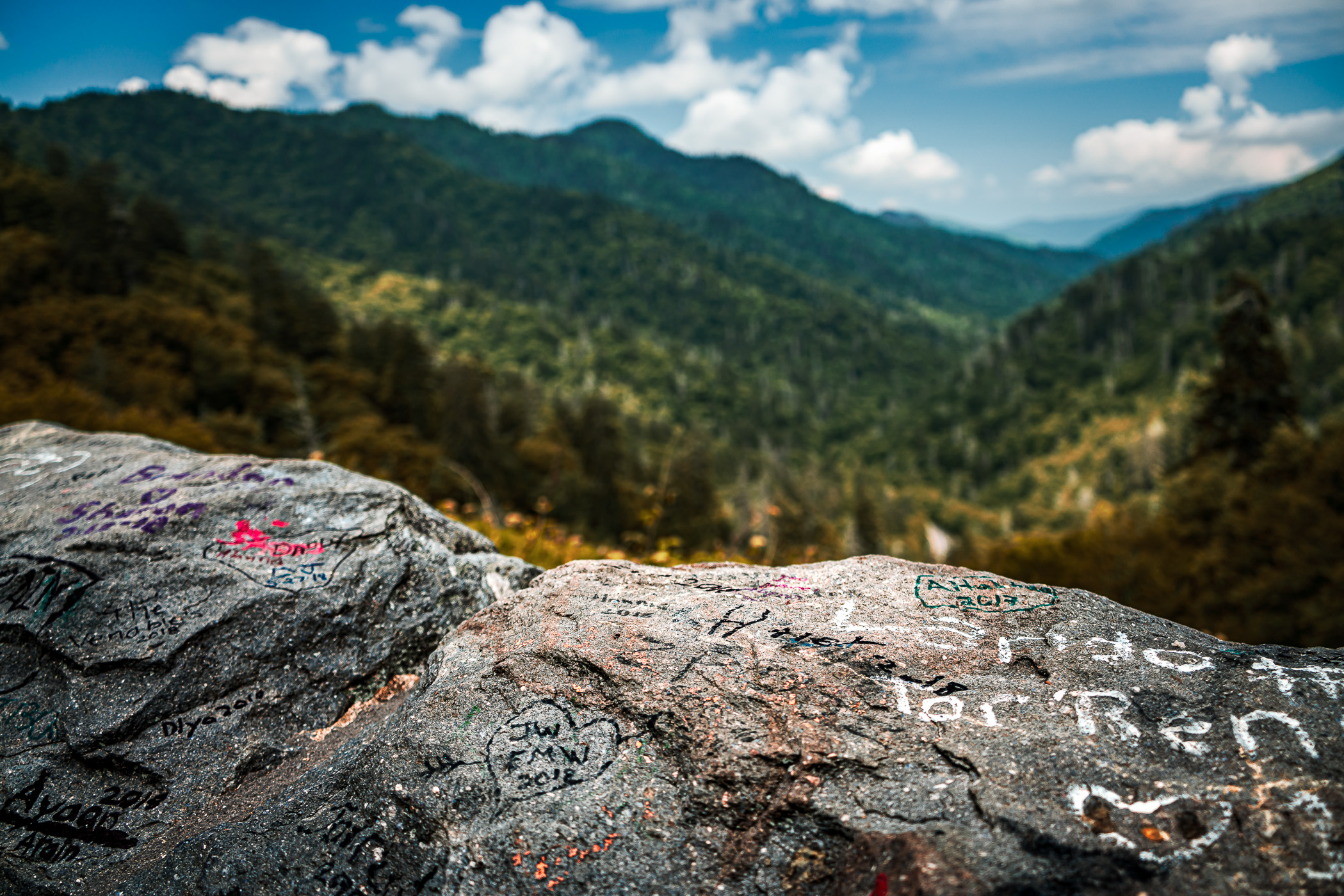 Graffiti-adorned rocks make up part of a retaining wall at a scenic overlook in Tennessee's Great Smoky Mountains National Park.