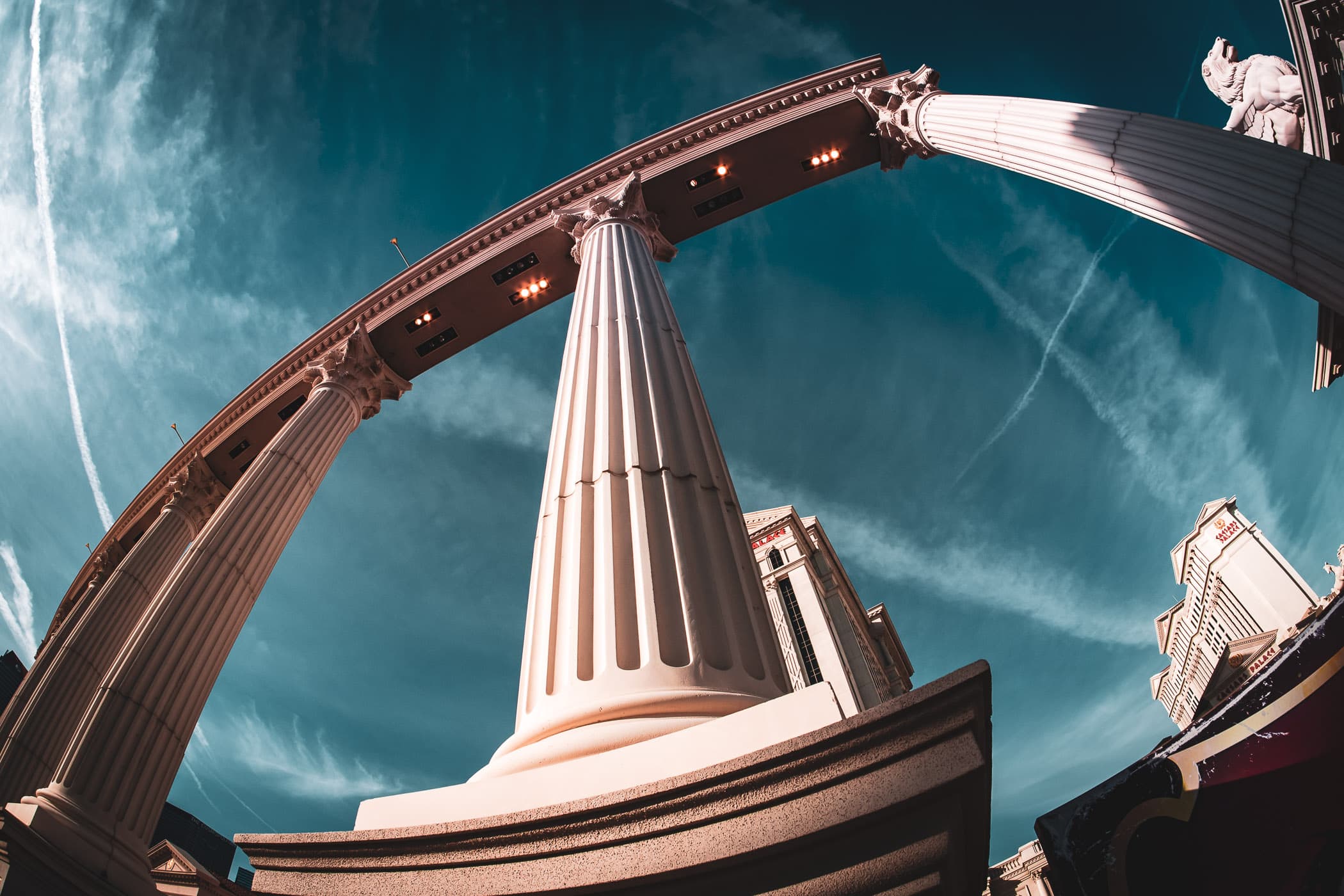 Decorative columns at Caesars Palace rise into the blue Las Vegas sky.