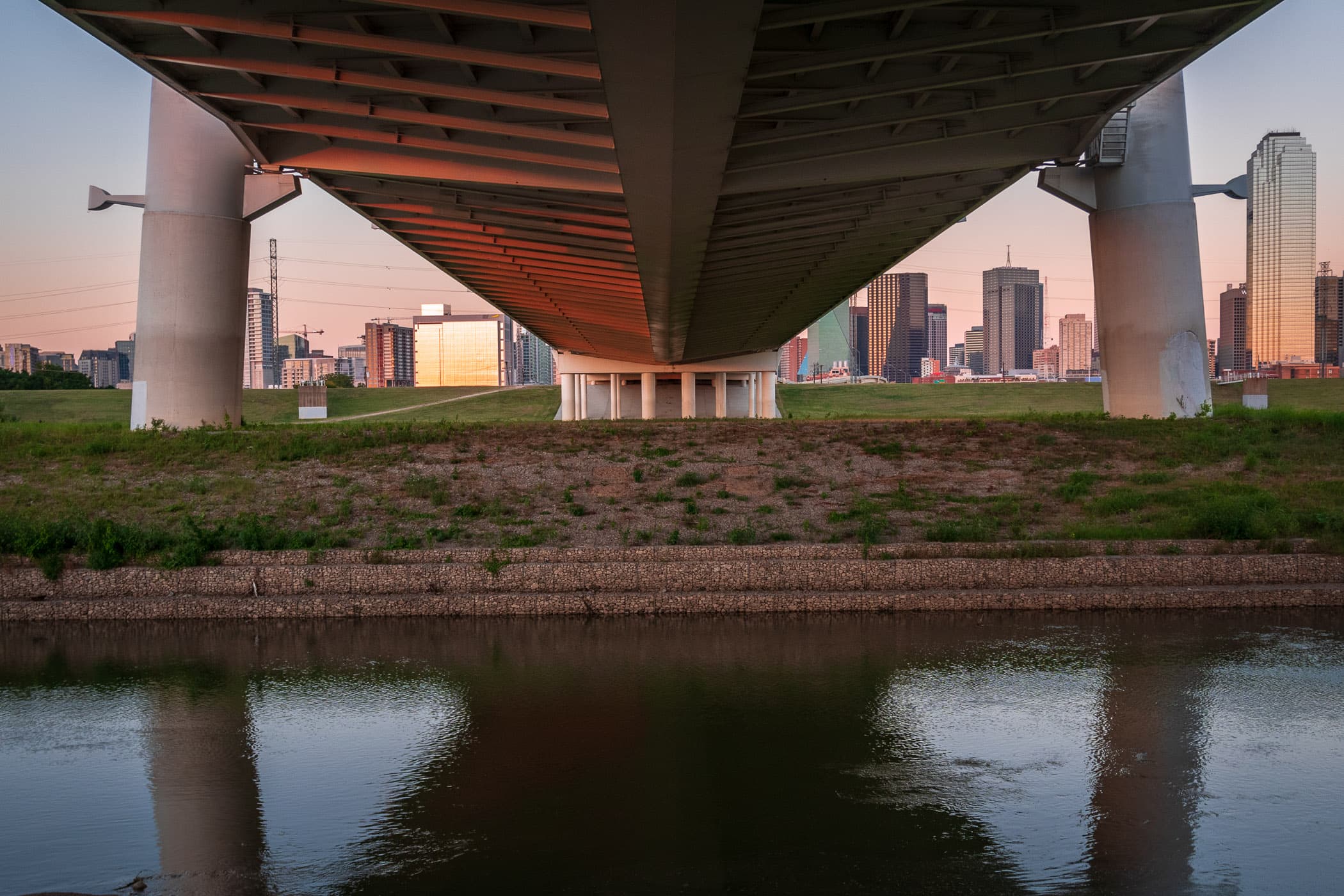 The Margaret Hunt Hill Bridge reaches over the Trinity River towards Downtown Dallas.