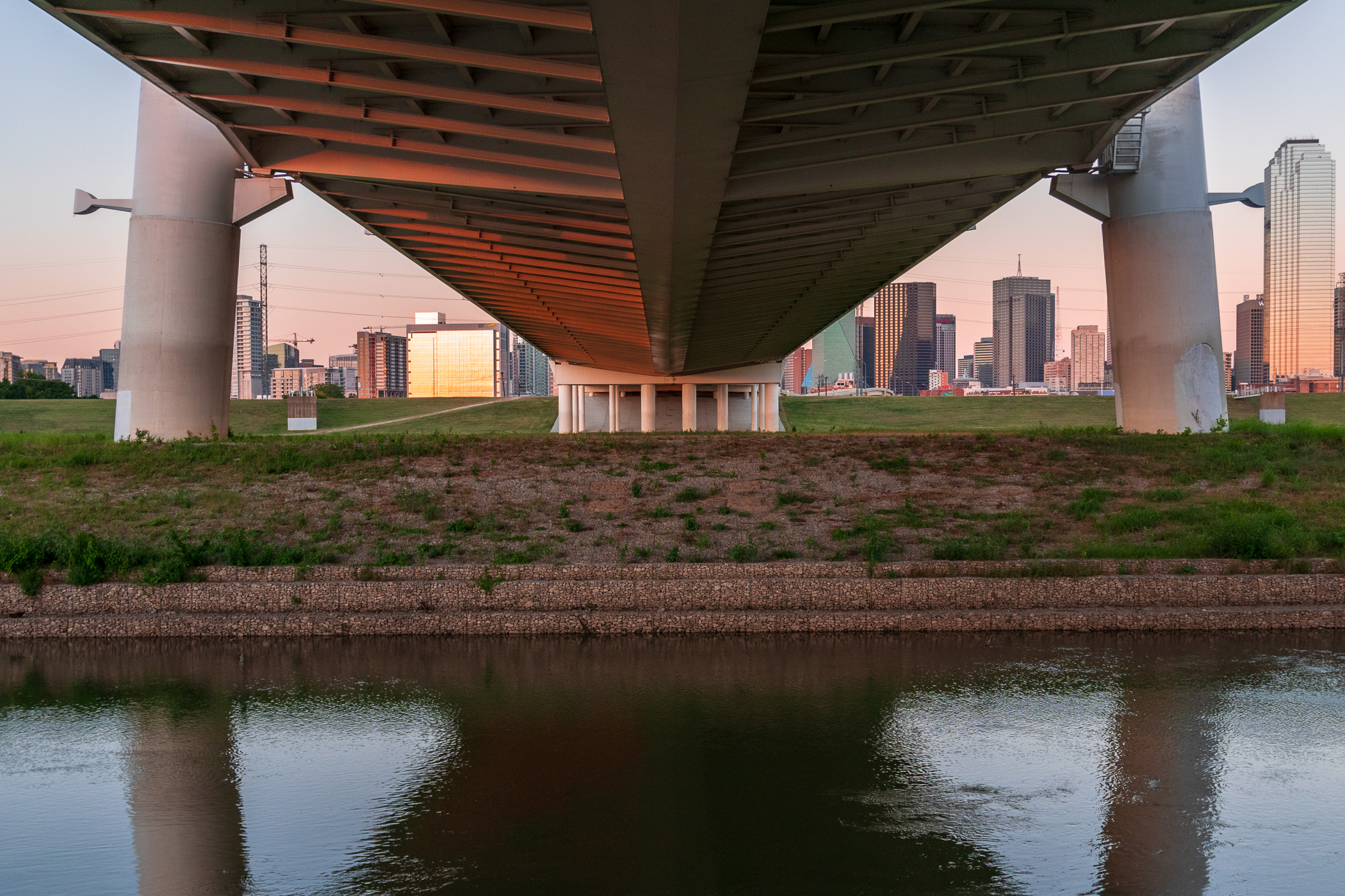 The Margaret Hunt Hill Bridge reaches over the Trinity River towards Downtown Dallas.