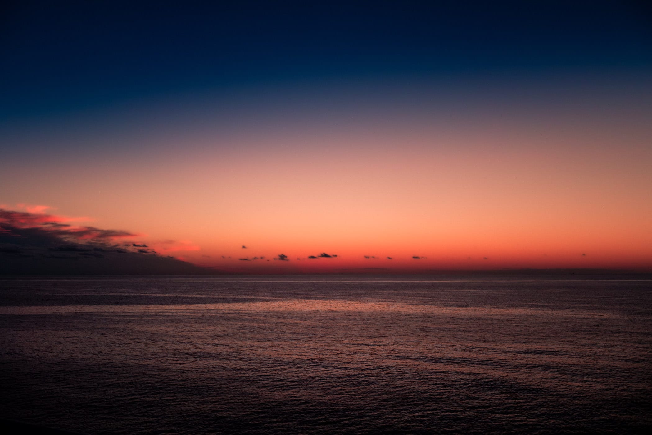 The last light of day illuminates the sky over the Gulf of Mexico, somewhere between Mexico's Yucatan Peninsula and the Texas coast.