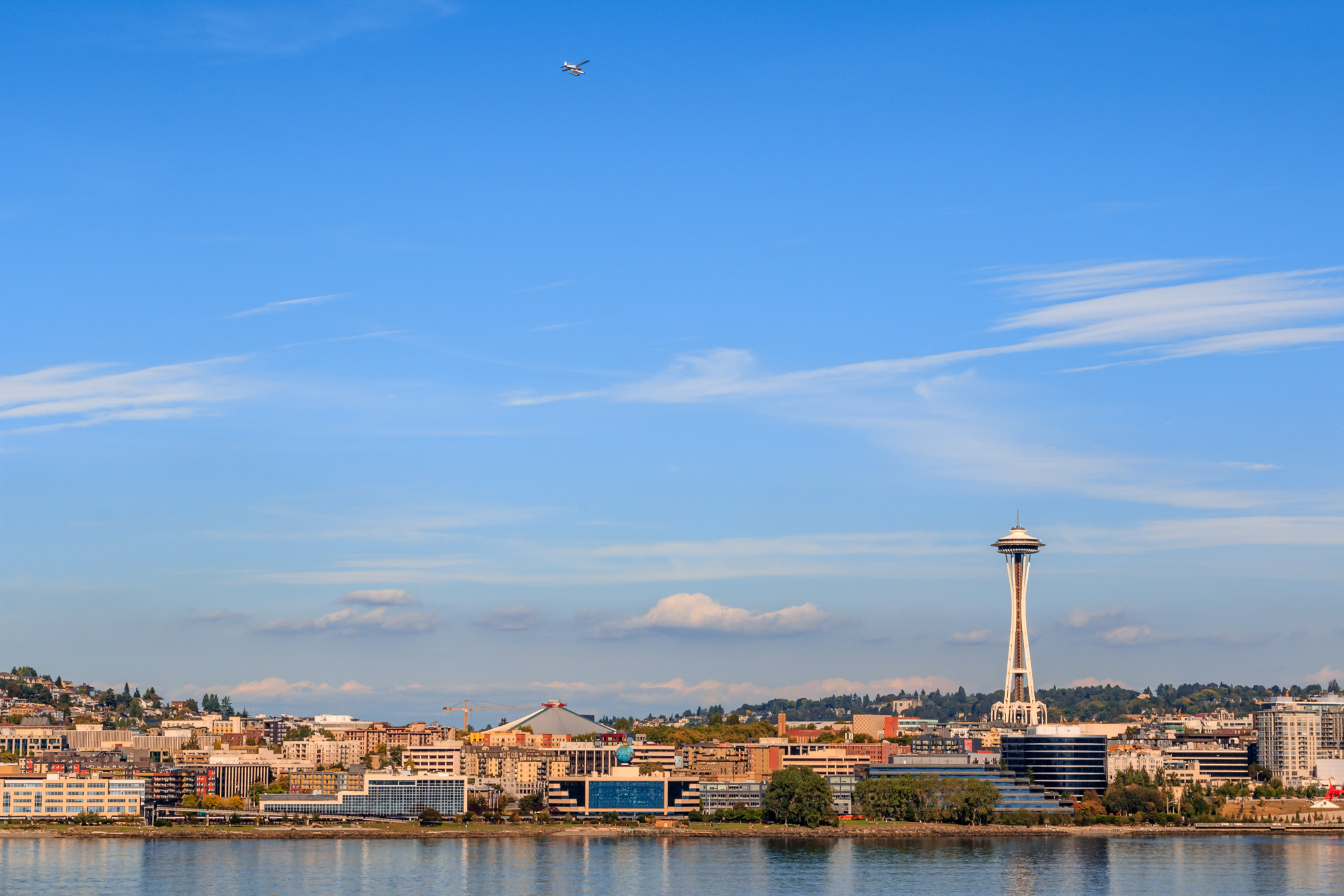 A seaplane flies over Seattle's Queen Anne neighborhood.