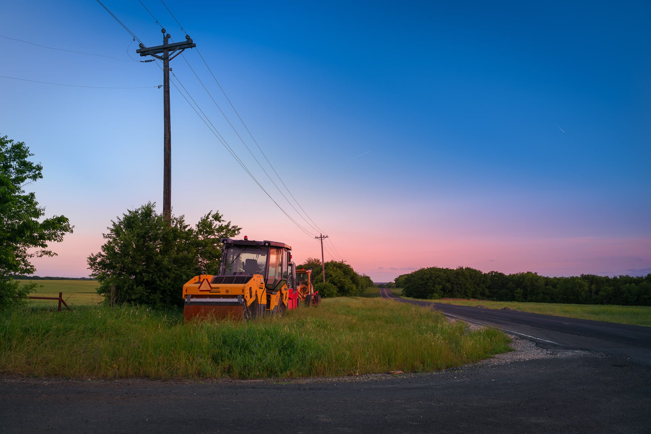 Construction equipment parked alongside a country road near Anna, Texas.