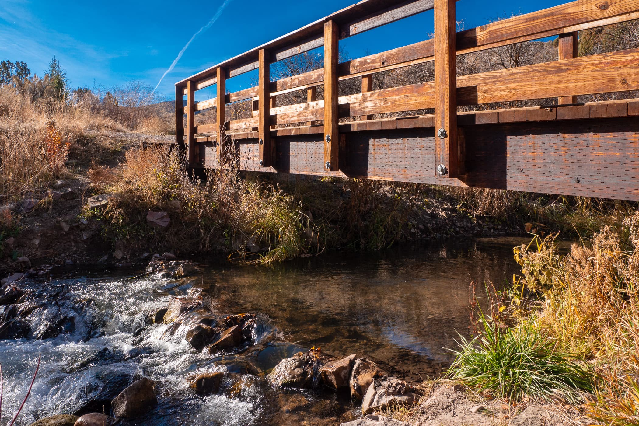 A pedestrian bridge crosses a small stream at Cherry Springs Nature Area near Pocatello, Idaho.