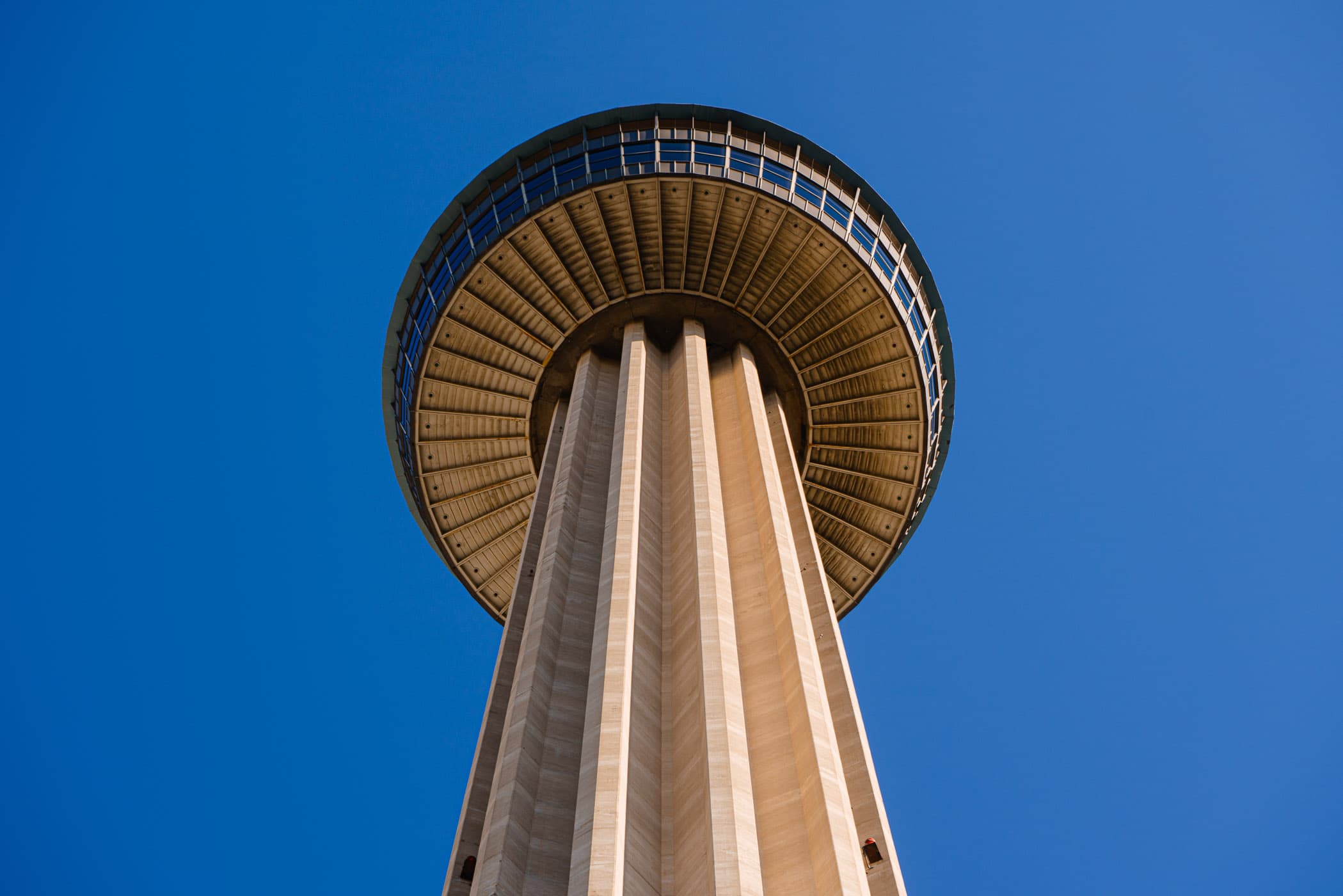 The 750-foot-tall Tower of the Americas rises into the clear blue sky over San Antonio, Texas.