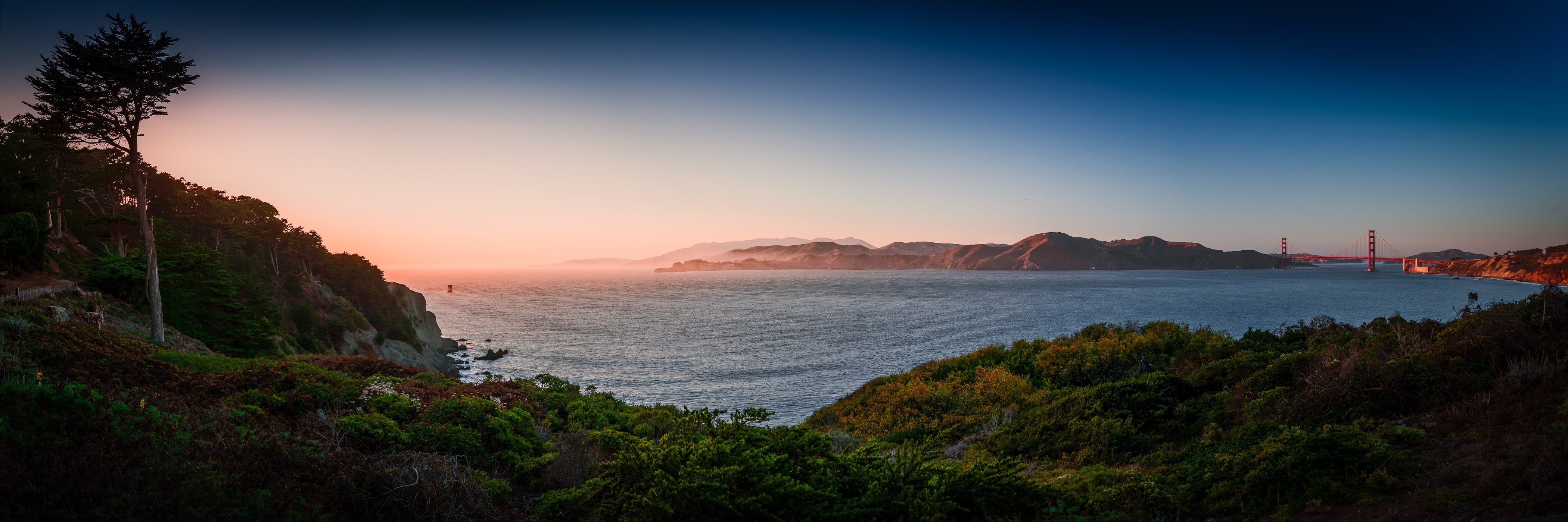 The sun sets on the Golden Gate—the narrow strait between San Francisco and the Marin Headlands that connects San Francisco Bay with the Pacific Ocean.