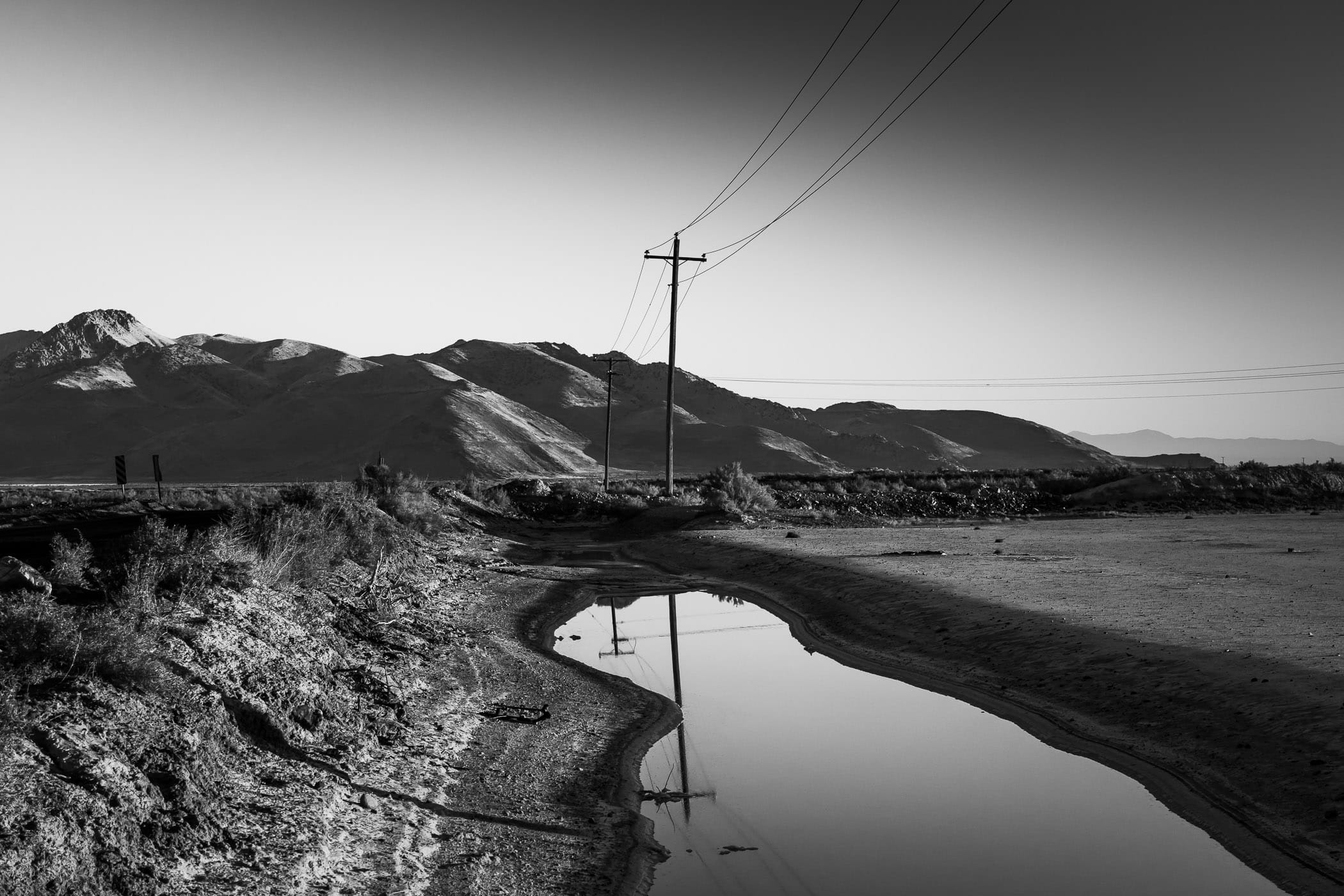 Power lines stretch along the road to Utah’s Stansbury Island along the shore of the Great Salt Lake.