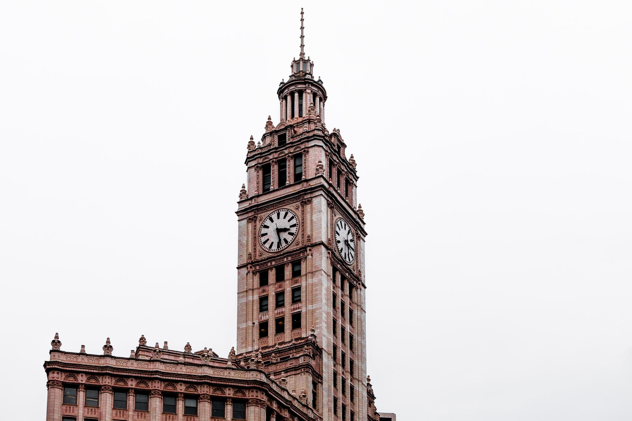 The Wrigley Building rises into the overcast Chicago sky.
