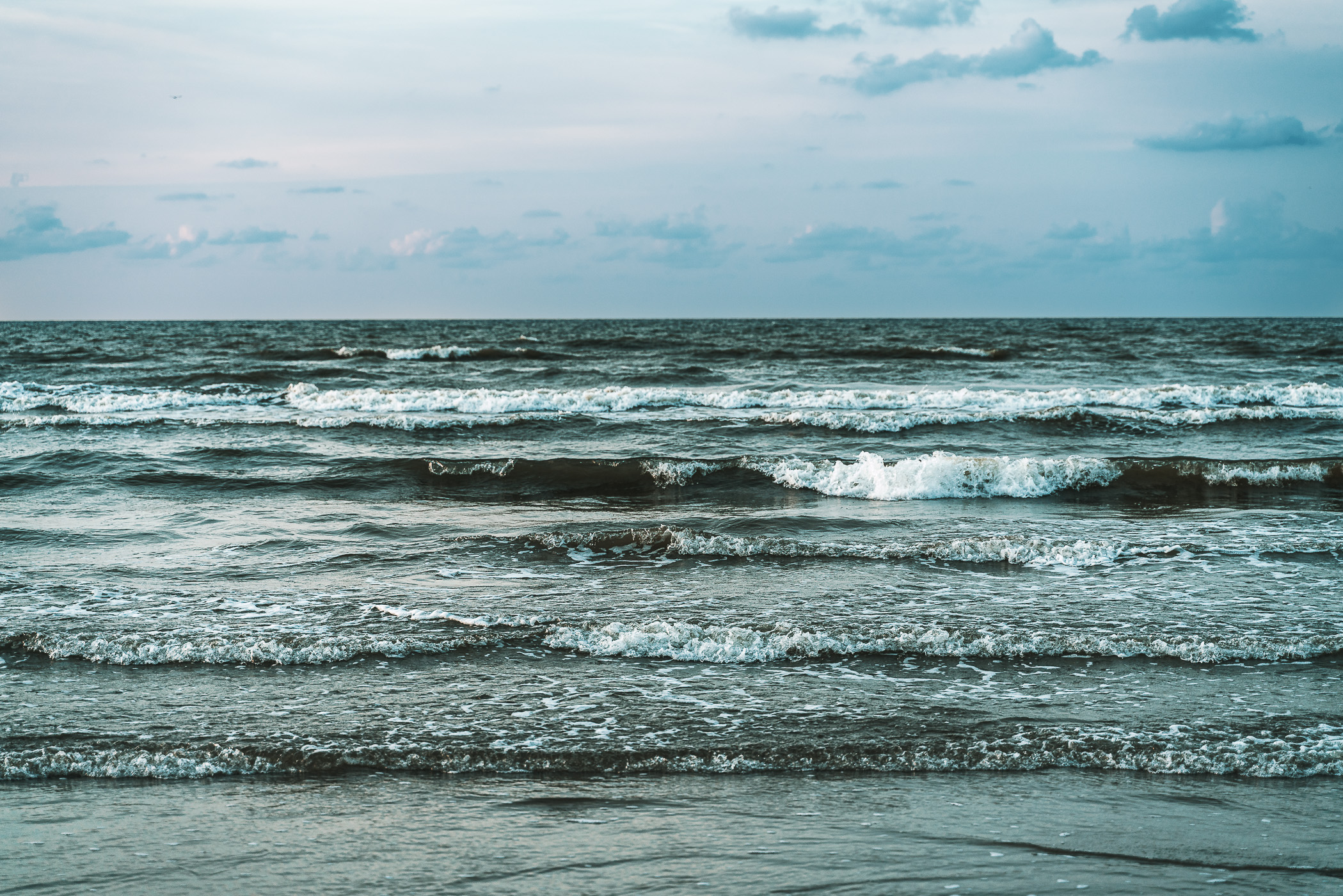 Waves roll ashore on a Galveston, Texas, beach.