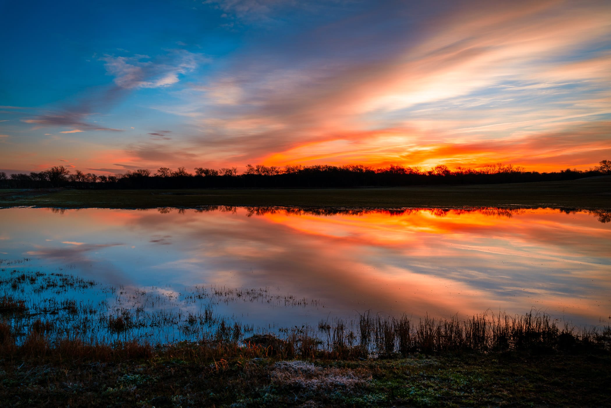 The sun rises on a pond at Texas' Hagerman National Wildlife Refuge.