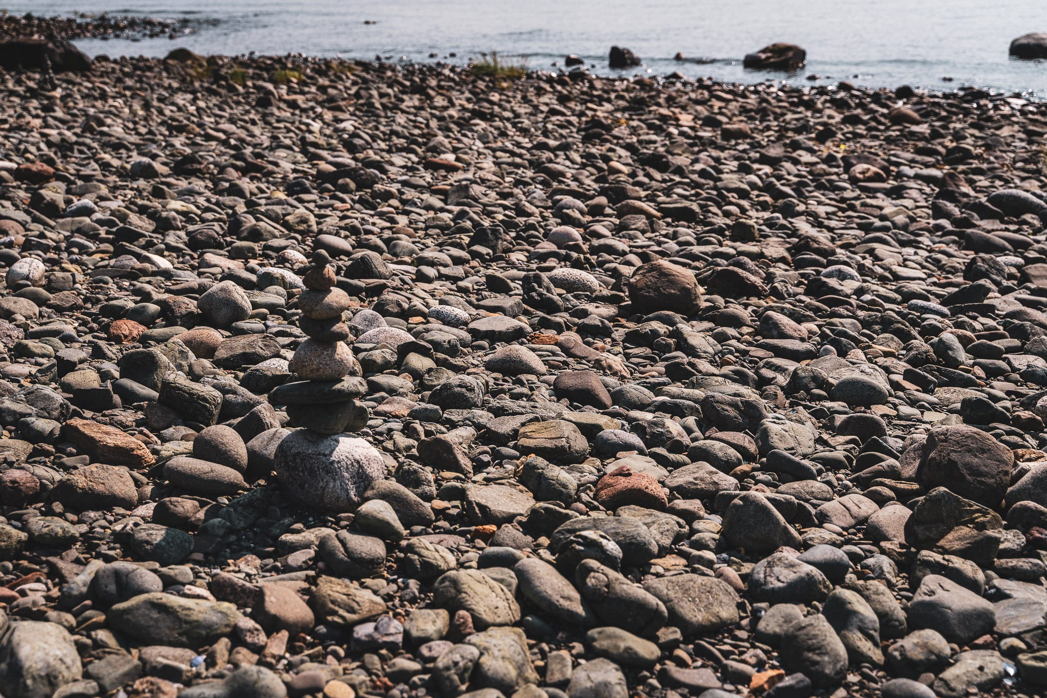 Stones stacked on a rocky shore in Juneau, Alaska.
