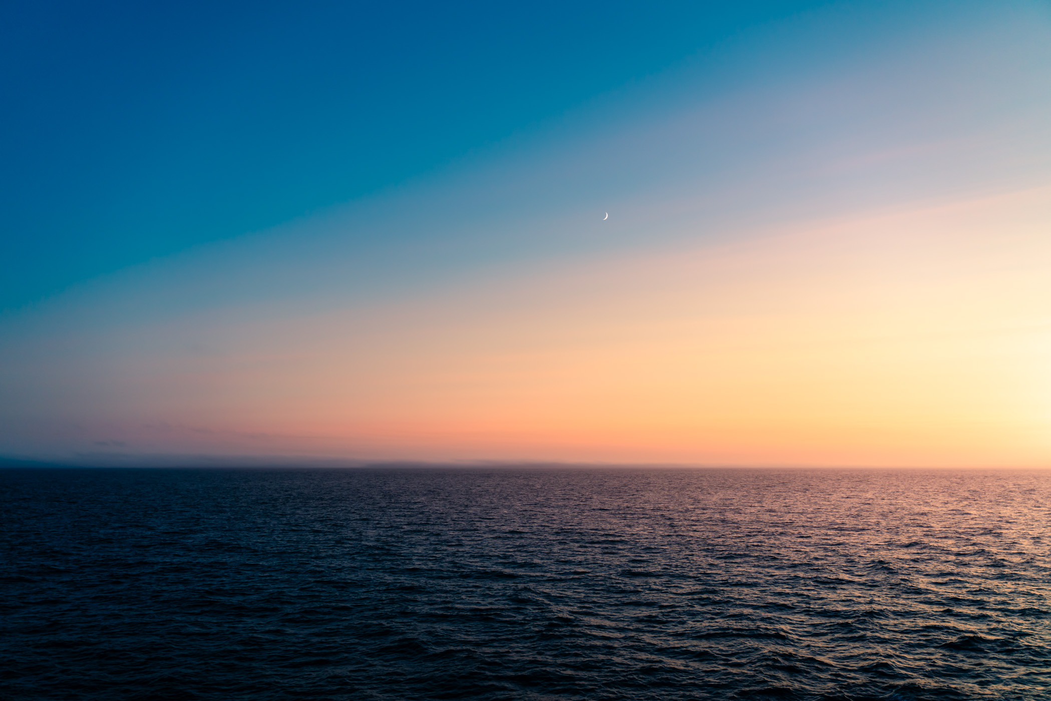 The Moon rises over the Pacific Ocean near Graham Island, British Columbia.