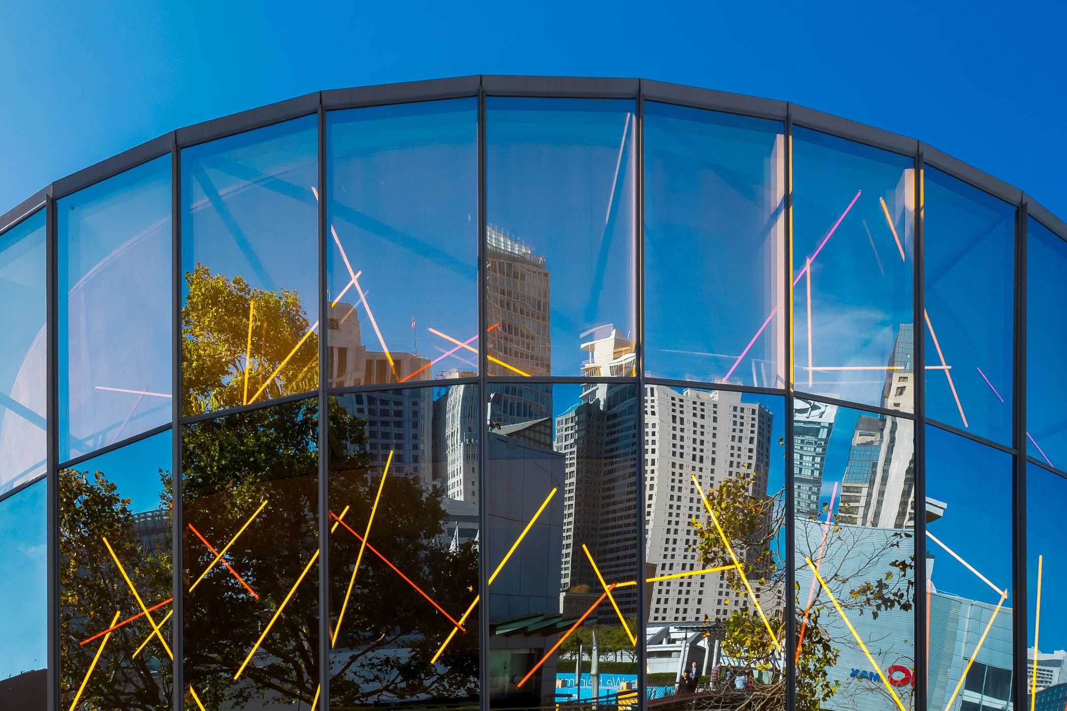 Skyscrapers are reflected in the glass façade of San Francisco's Children's Creativity Museum.