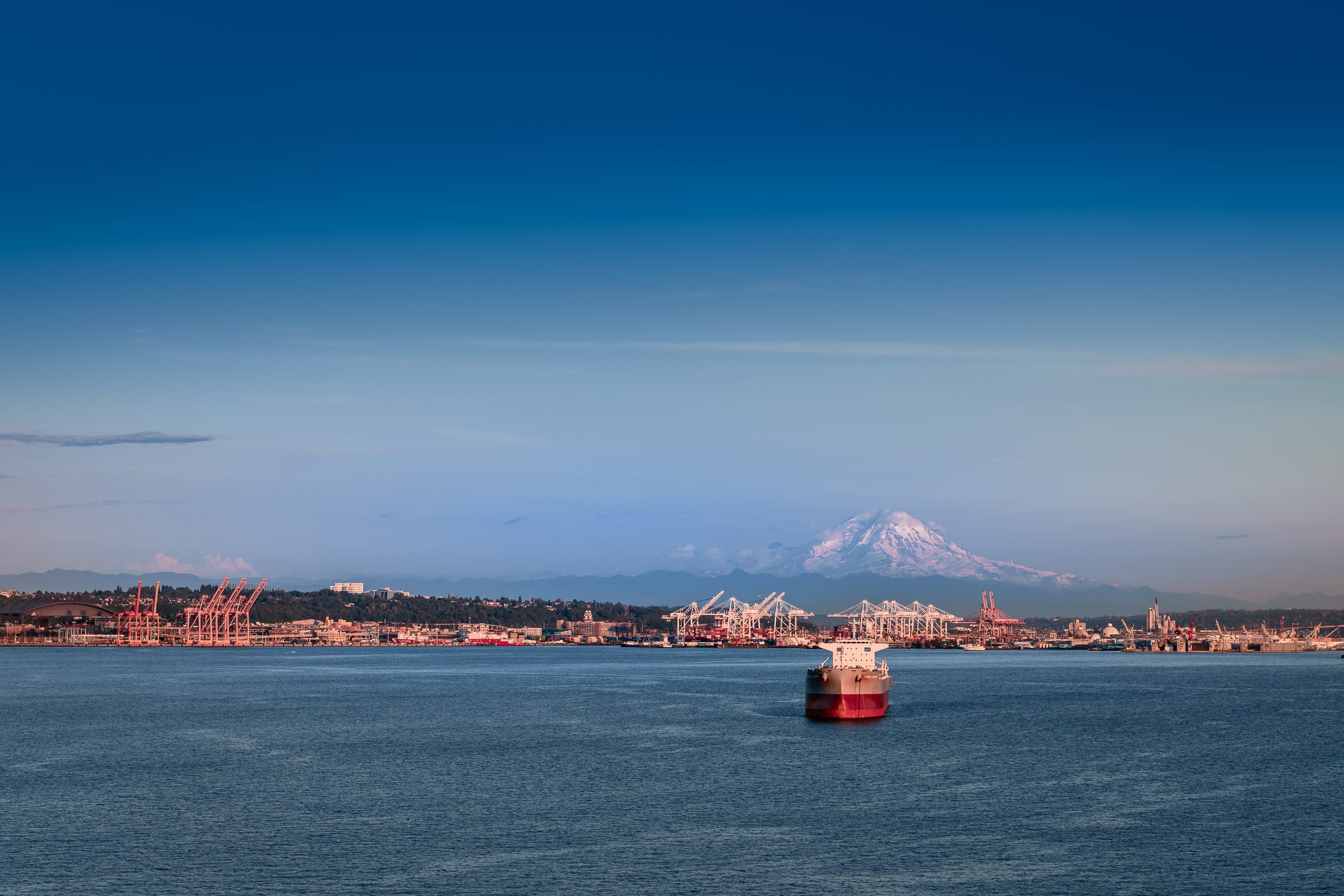 Mount Rainier rises over the Port of Seattle.