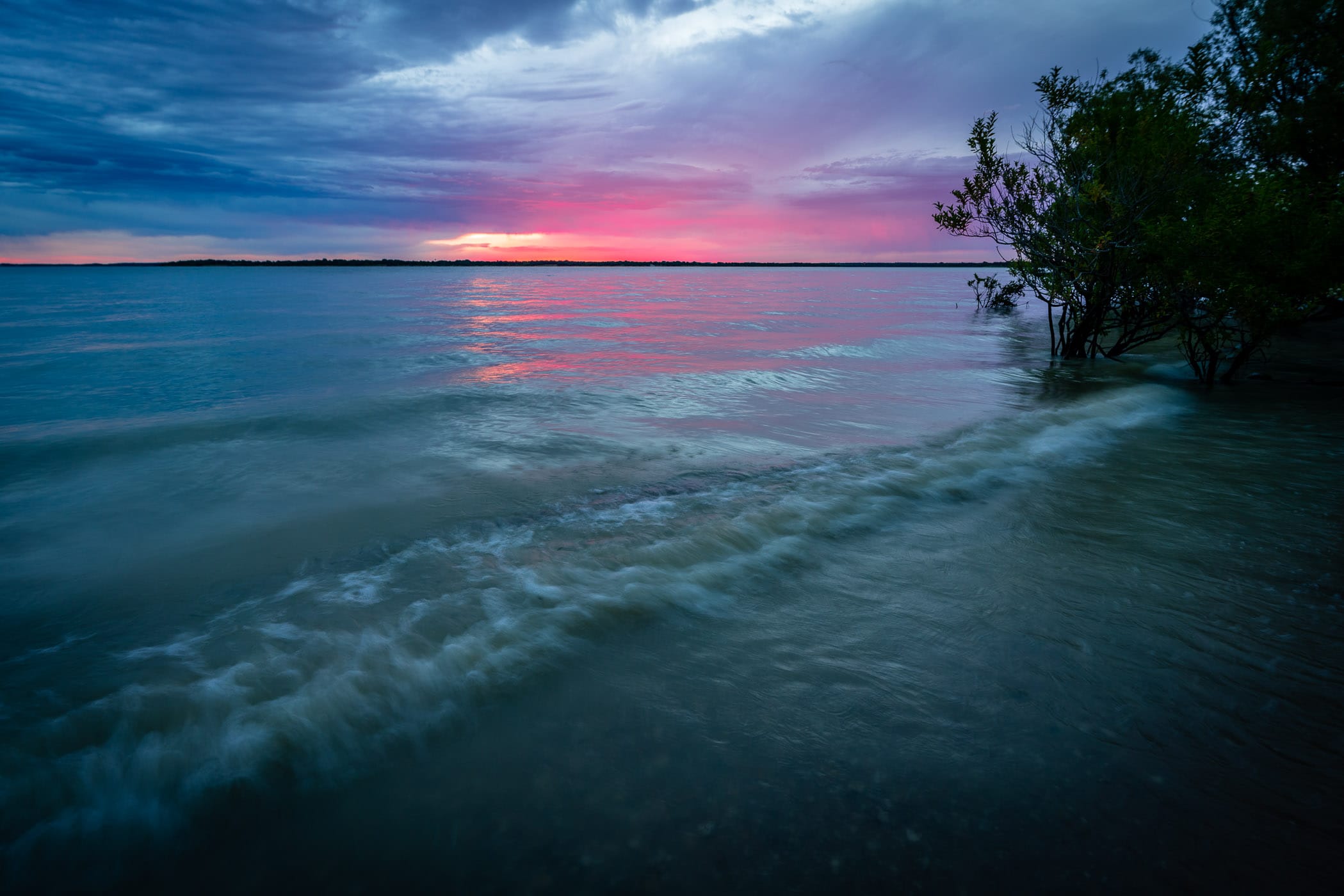 Waves roll onto the shore of North Texas' Lake Lavon.