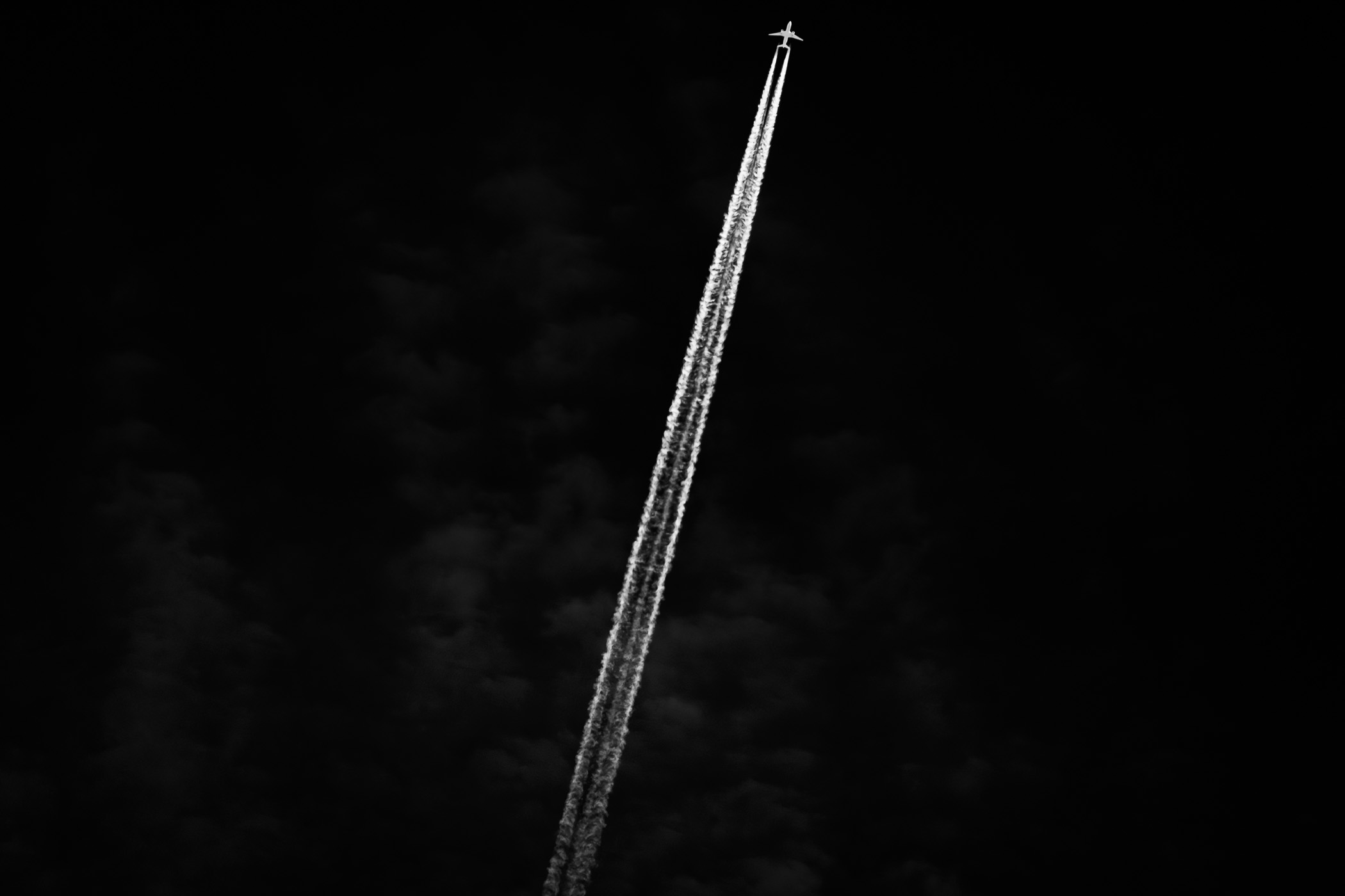 A jet slashes a contrail through the sky over the Mojave National Preserve, California.