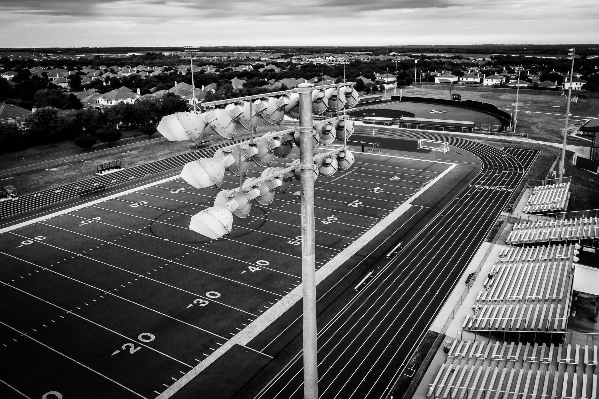 Lights loom over the football stadium at McKinney North High School, McKinney, Texas.