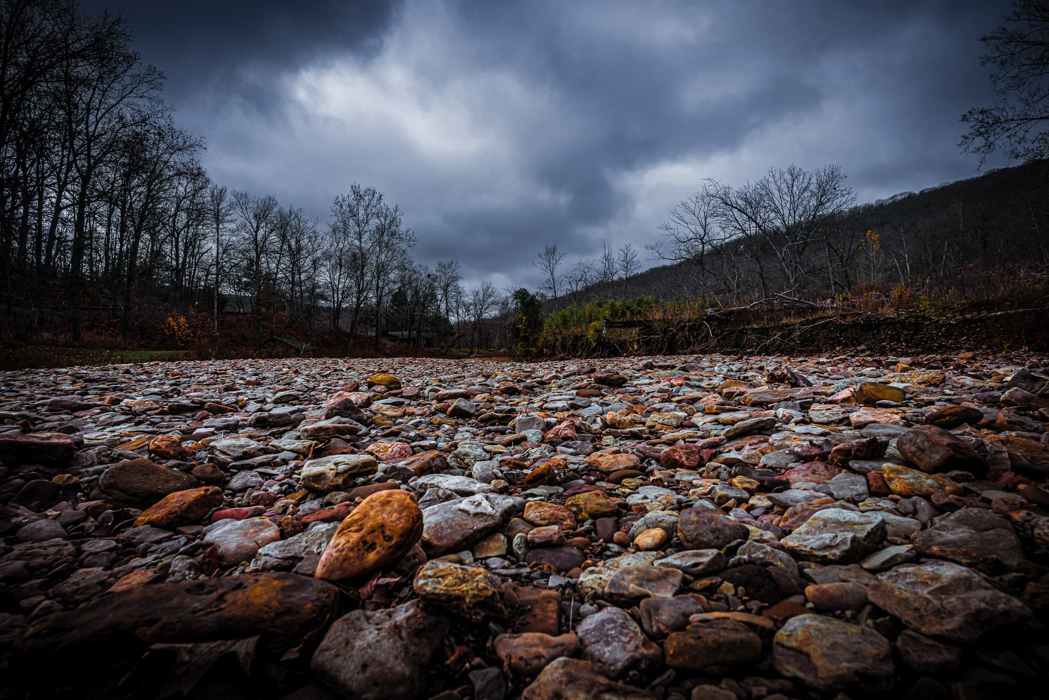 The colorful rocks of a dry riverbed at Devil's Den State Park, Arkansas.