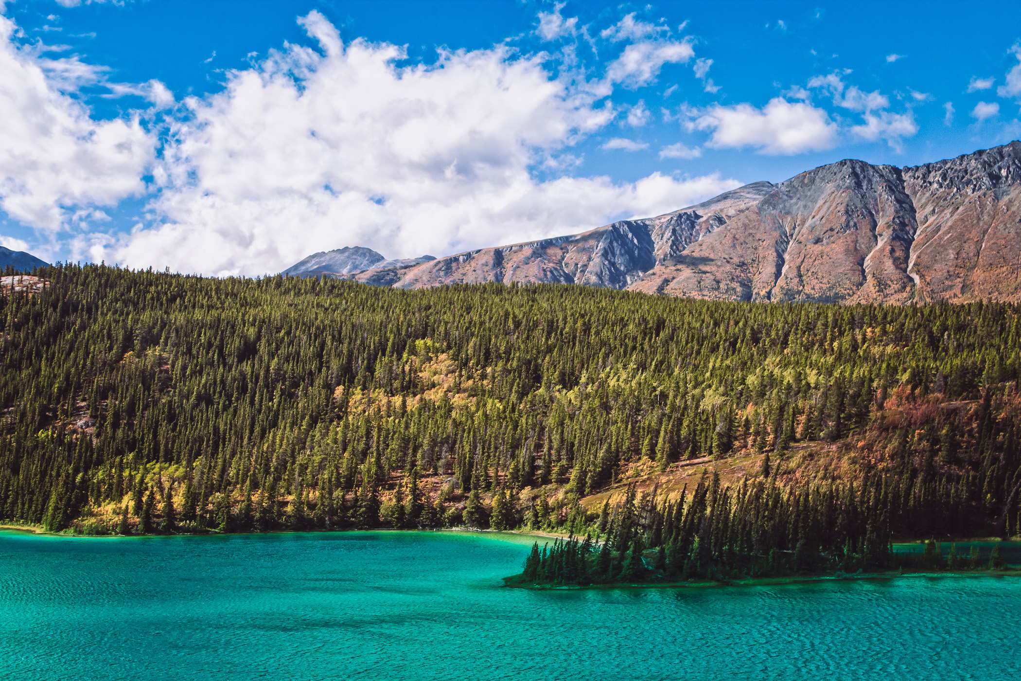 The deep blue-green waters of Emerald Lake, nestled in the mountains just north of Carcross, Yukon Territory, Canada.