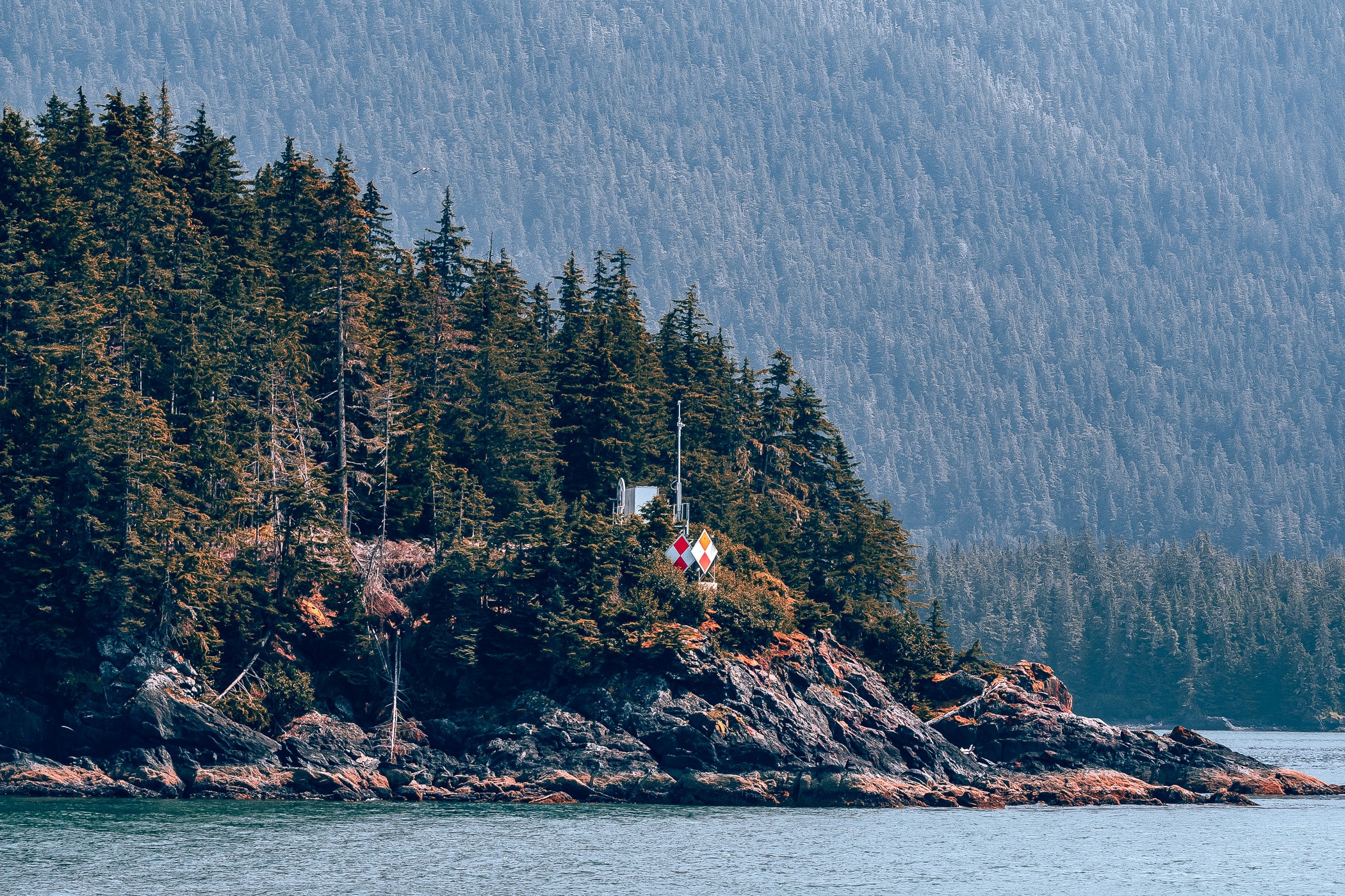 A maritime navigation beacon on a small island in Alaska's Stephens Passage, near Juneau.