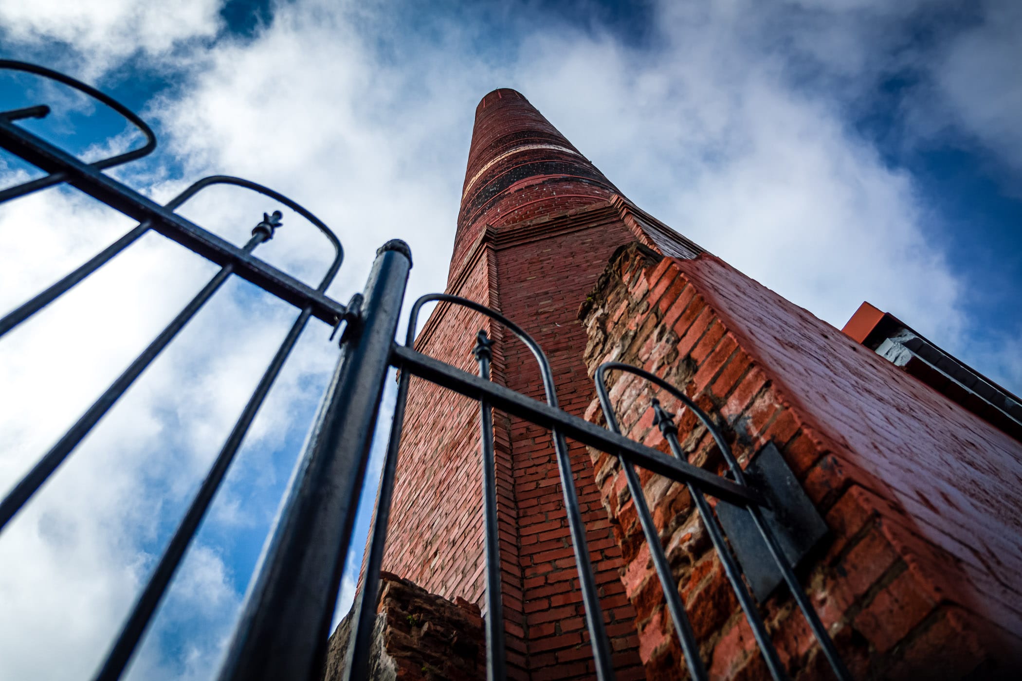A brick chimney—a relic of a the first ice manufacturing plant in Texas—rises towards the clouds over Downtown Galveston, Texas.