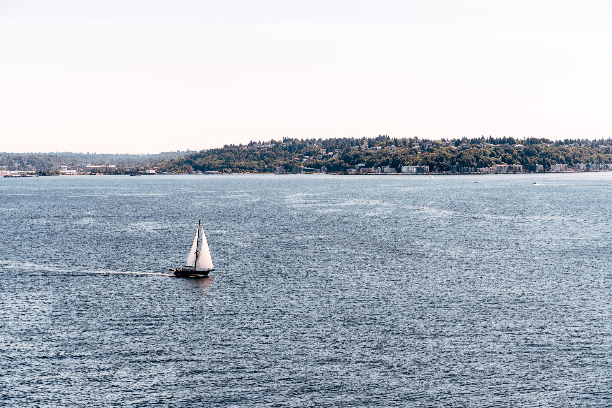 A sailboat plies the waters of the Puget Sound in the Salish Sea near Seattle, Washington.