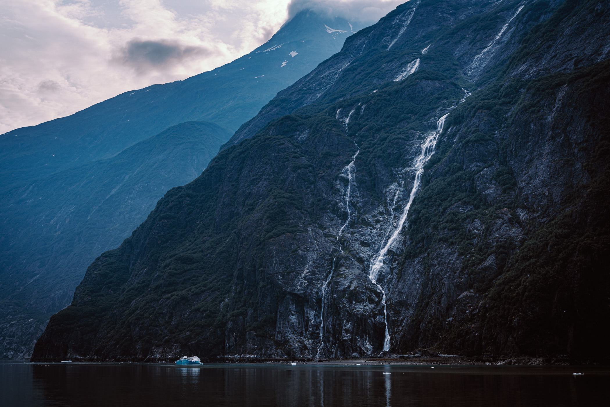 Water cascades down the side of a mountain in Alaska's Tracy Arm Fjord.