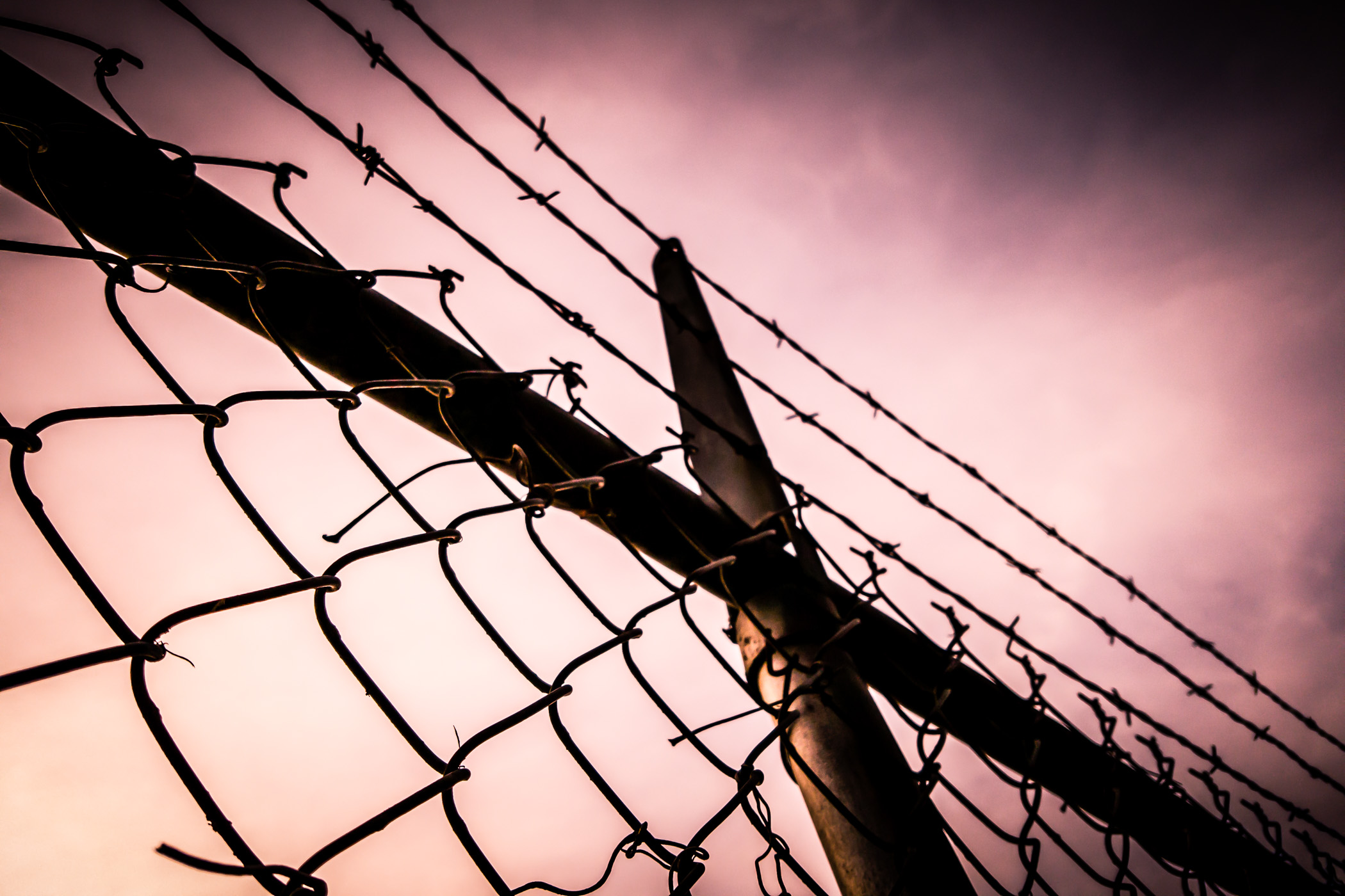 Barbed wire tops a fence in Addison, Texas.