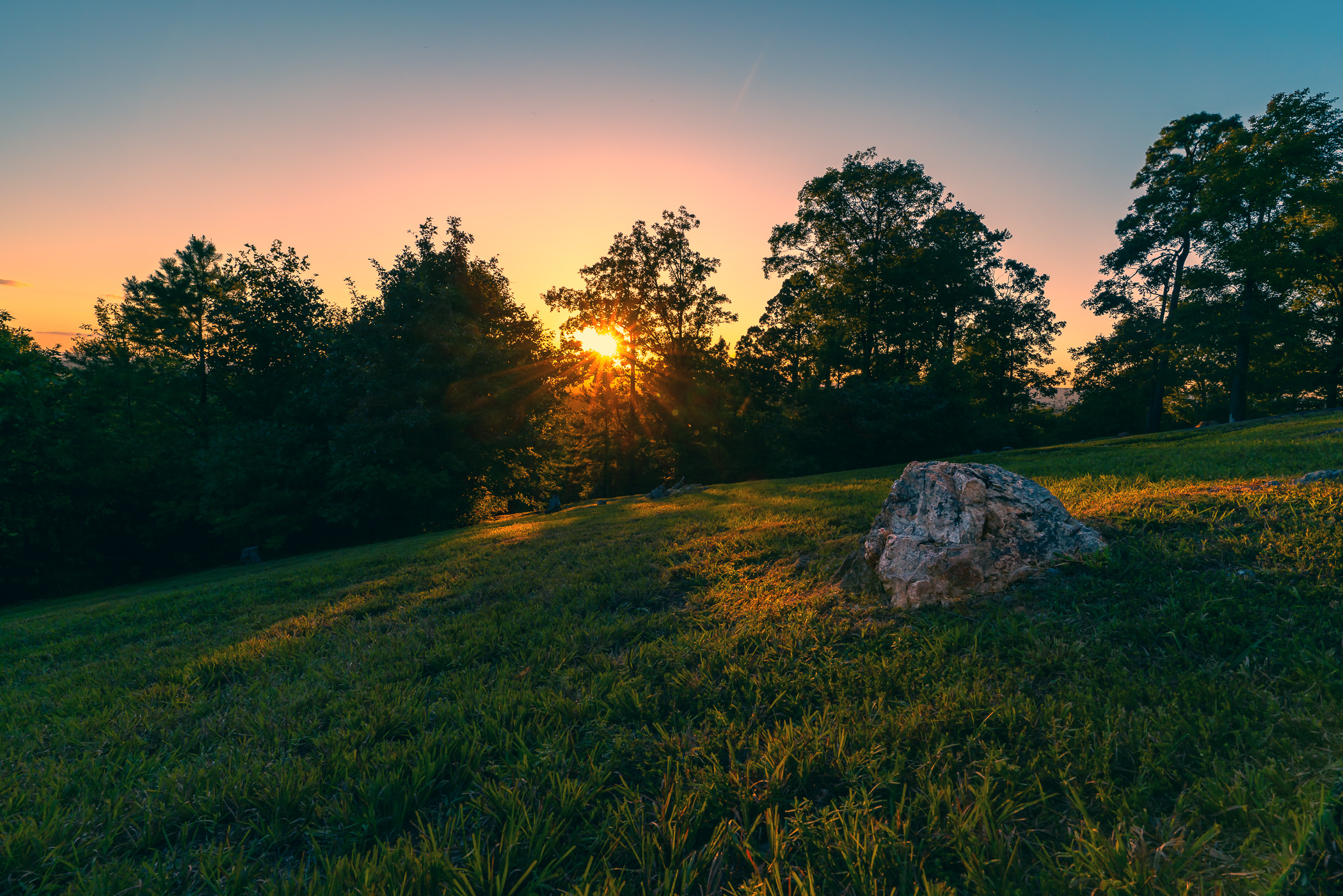 The sun sets on a hill near Mena, Arkansas.