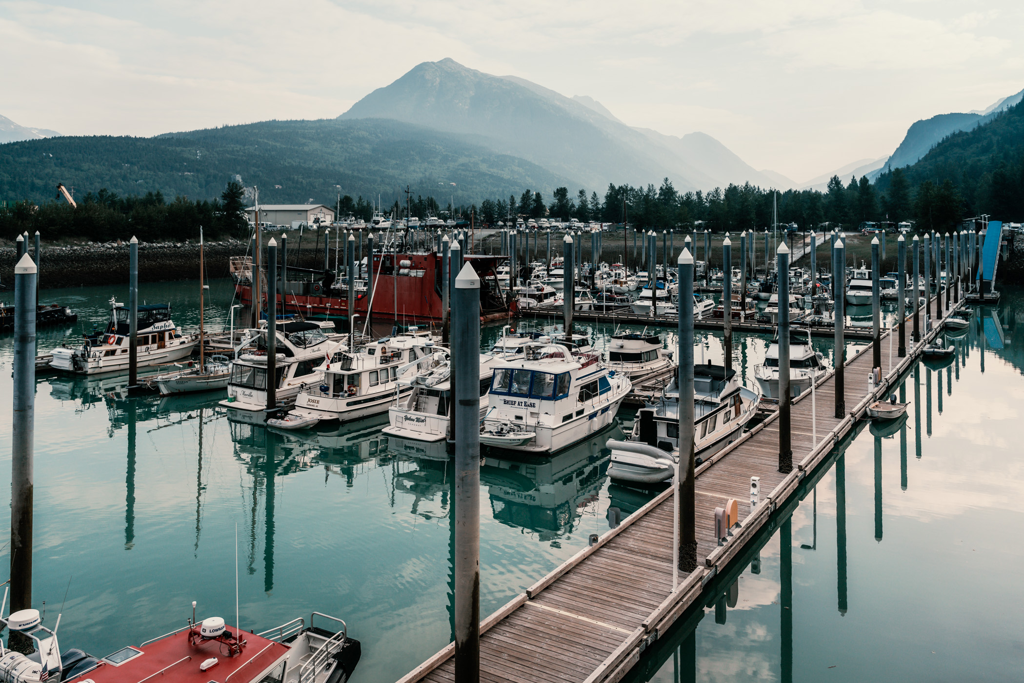 The sun rises on boats in the harbor at Skagway, Alaska.