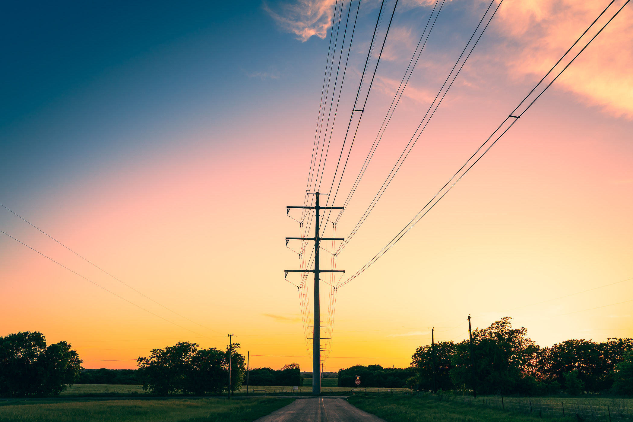 Power lines recede into the distance as the sun sets on North Texas near Chambersville.