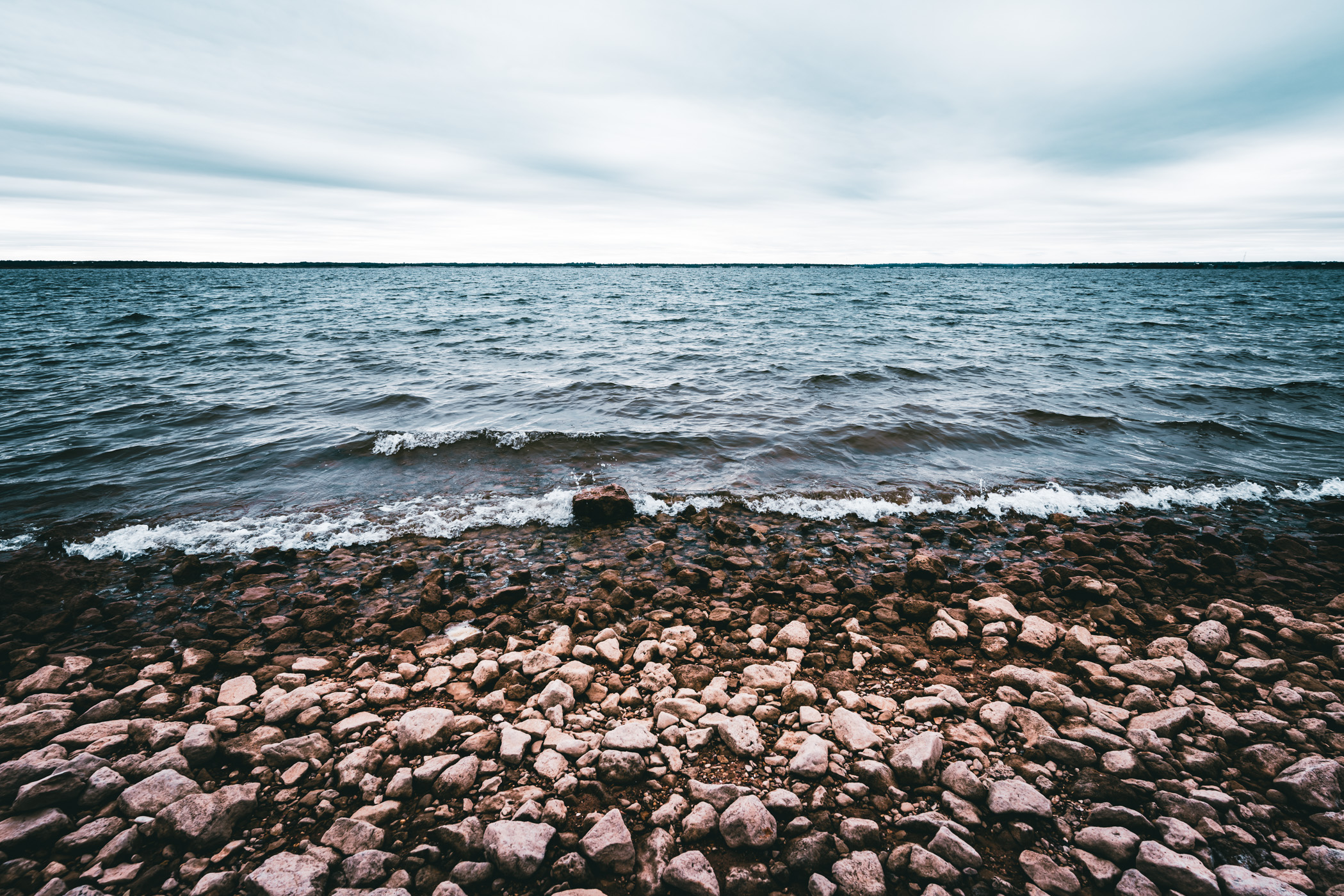 The rocky, windswept shore of Central Texas' Lake Whitney.