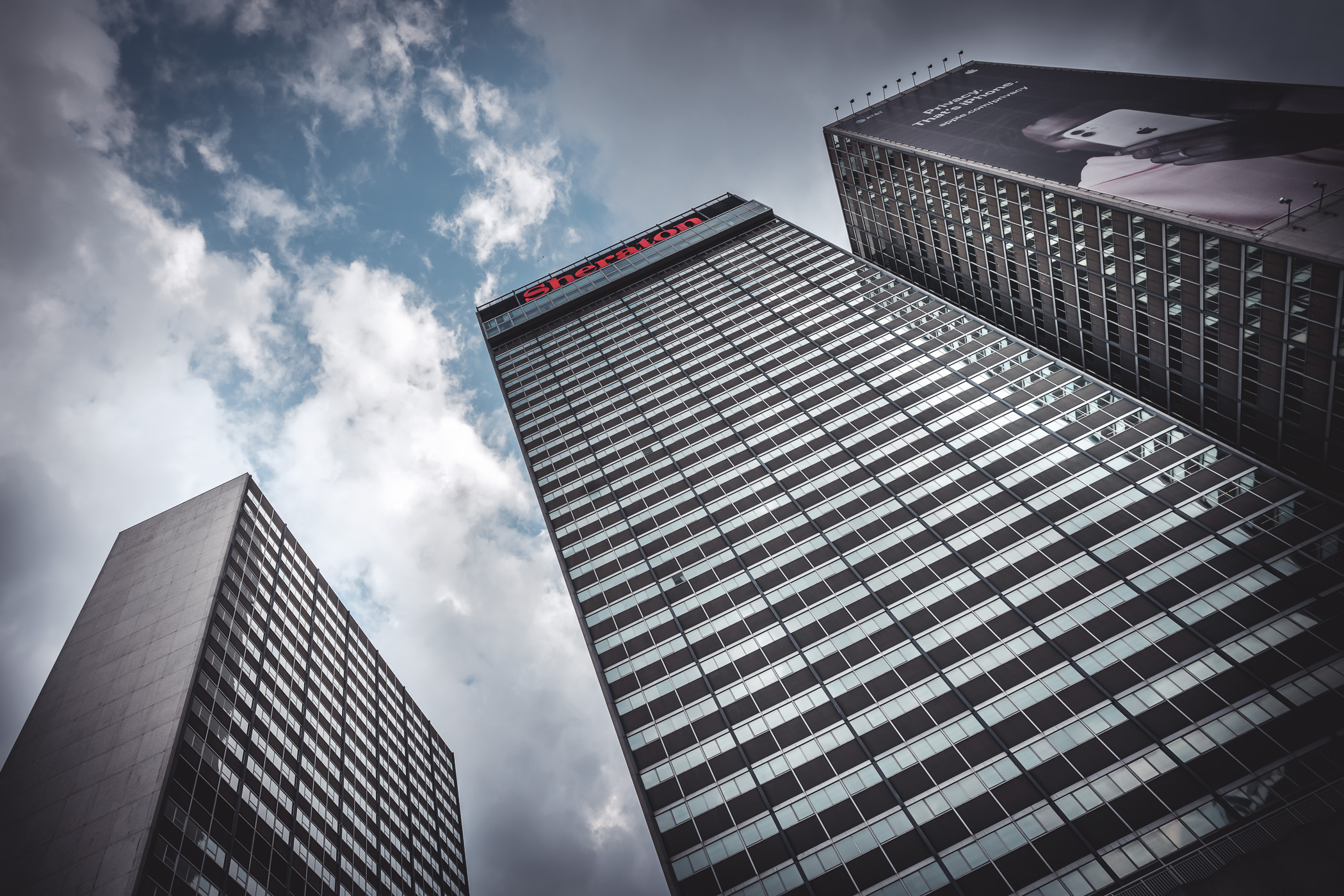 The three towers of Downtown Dallas' Sheraton Hotel reach for the North Texas clouds.